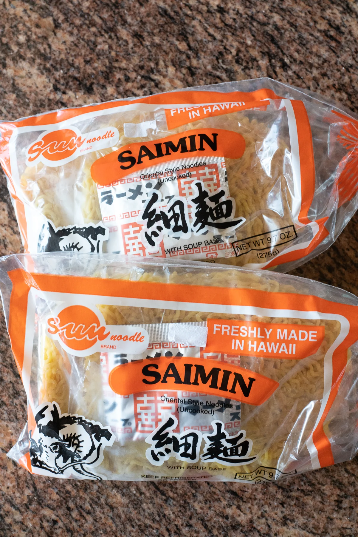 Packages of saimin noodles and seasoning powder from the supermarket.