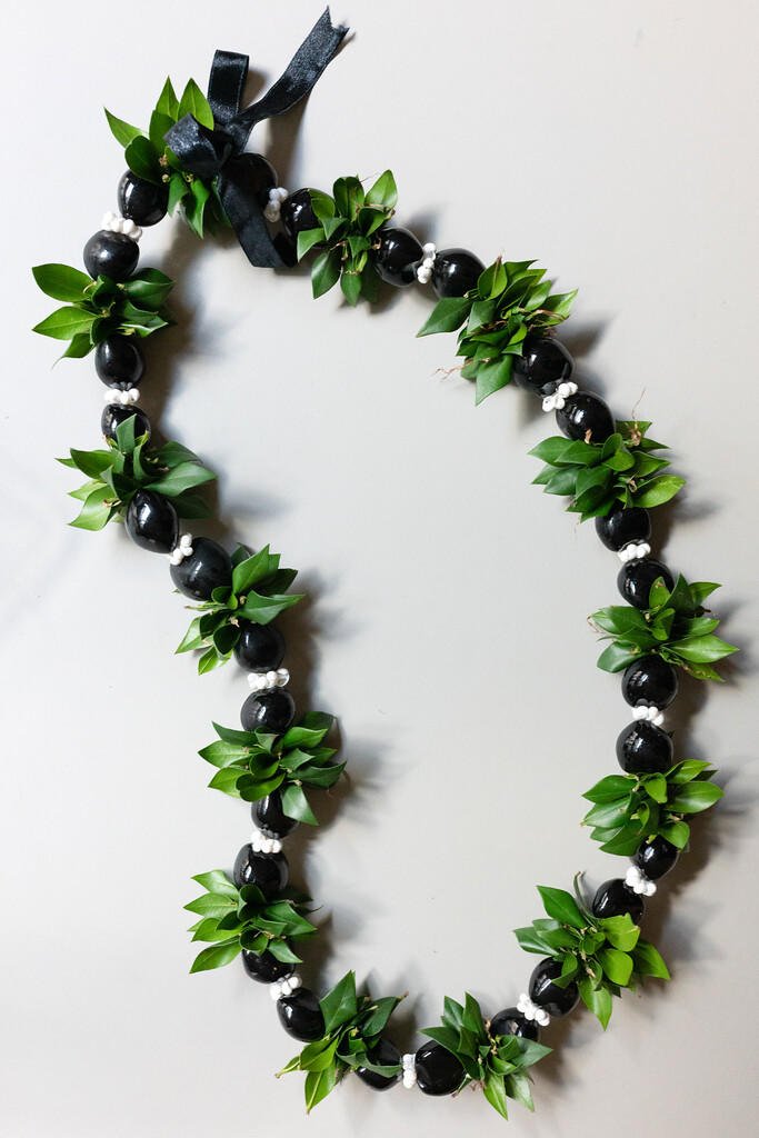 A lei made from kukui nuts and ti leaves