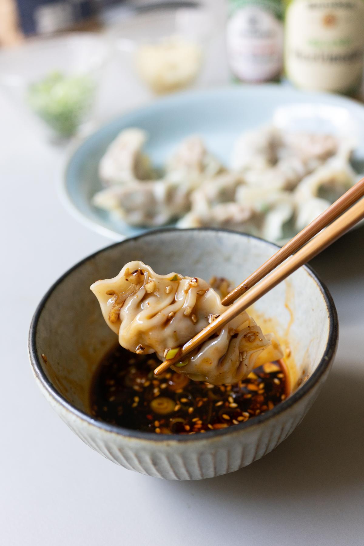 Dipping a dumpling in the Dumpling Dipping Sauce