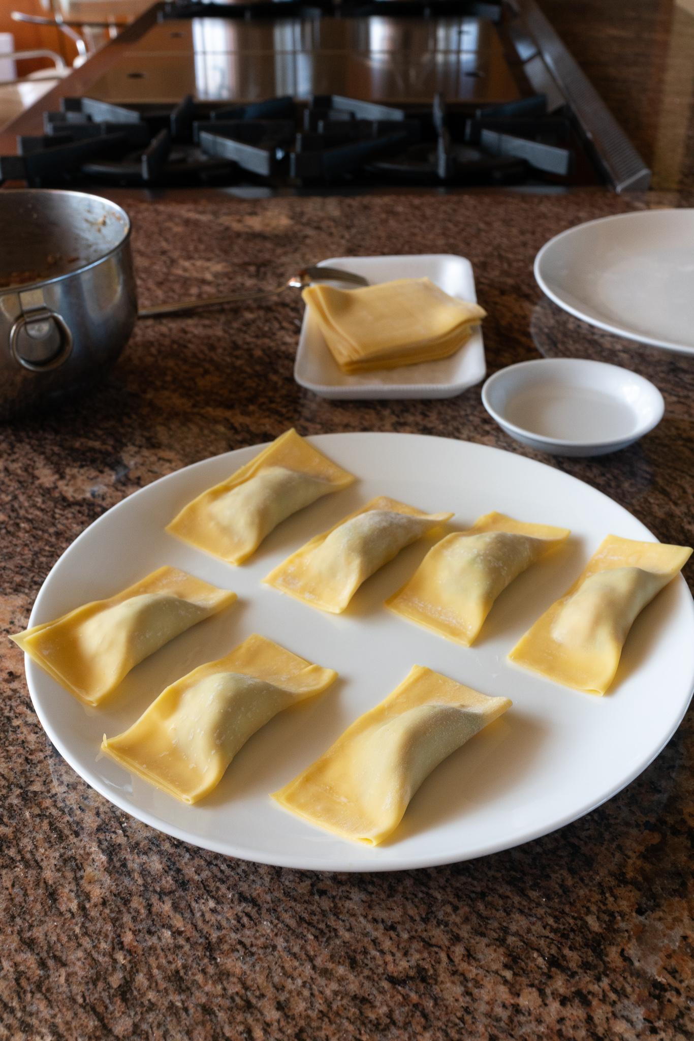 A plate of folded Gau Gee, waiting to be deep fried.