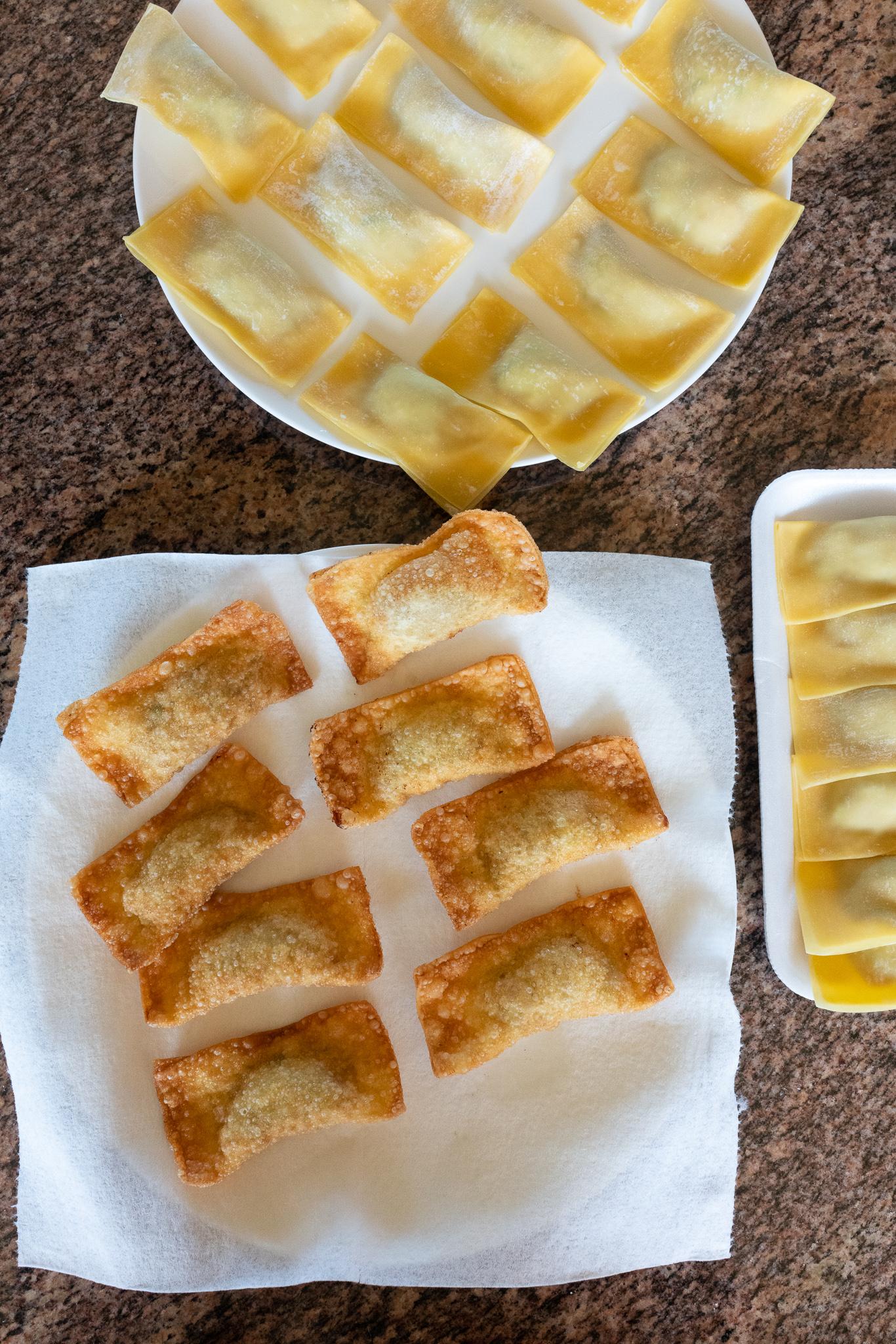 A batch of fresh fried Gau Gee on a plate. A batch of just folded Gau Gee (not yet fried) on another plate.