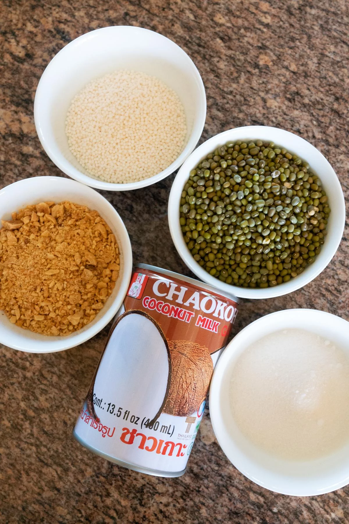 Ingredients for Vietnamese Mung Bean Dessert (Che Dau Xanh): dried green mung beans, coconut milk, small tapioca pearls, sugar, and crushed peanuts