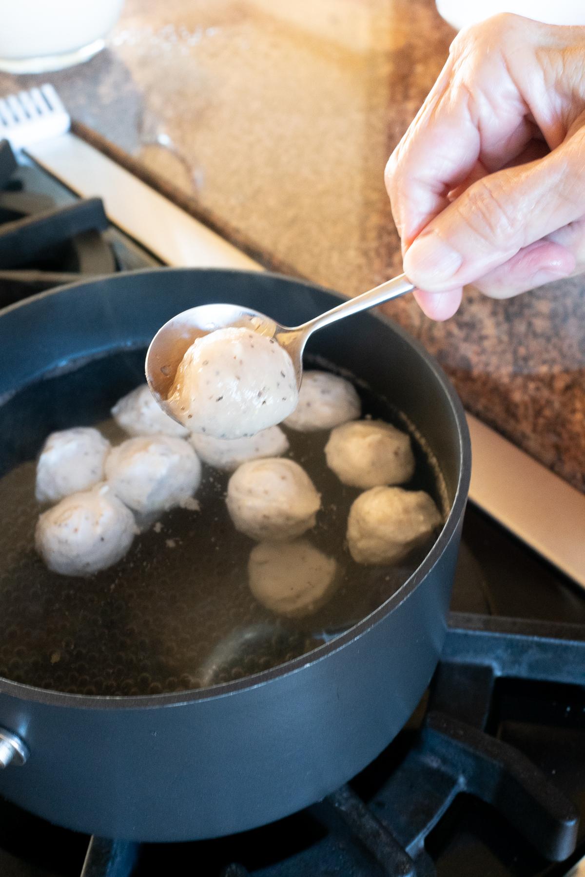 Boiling Fish Balls in a pot of water.