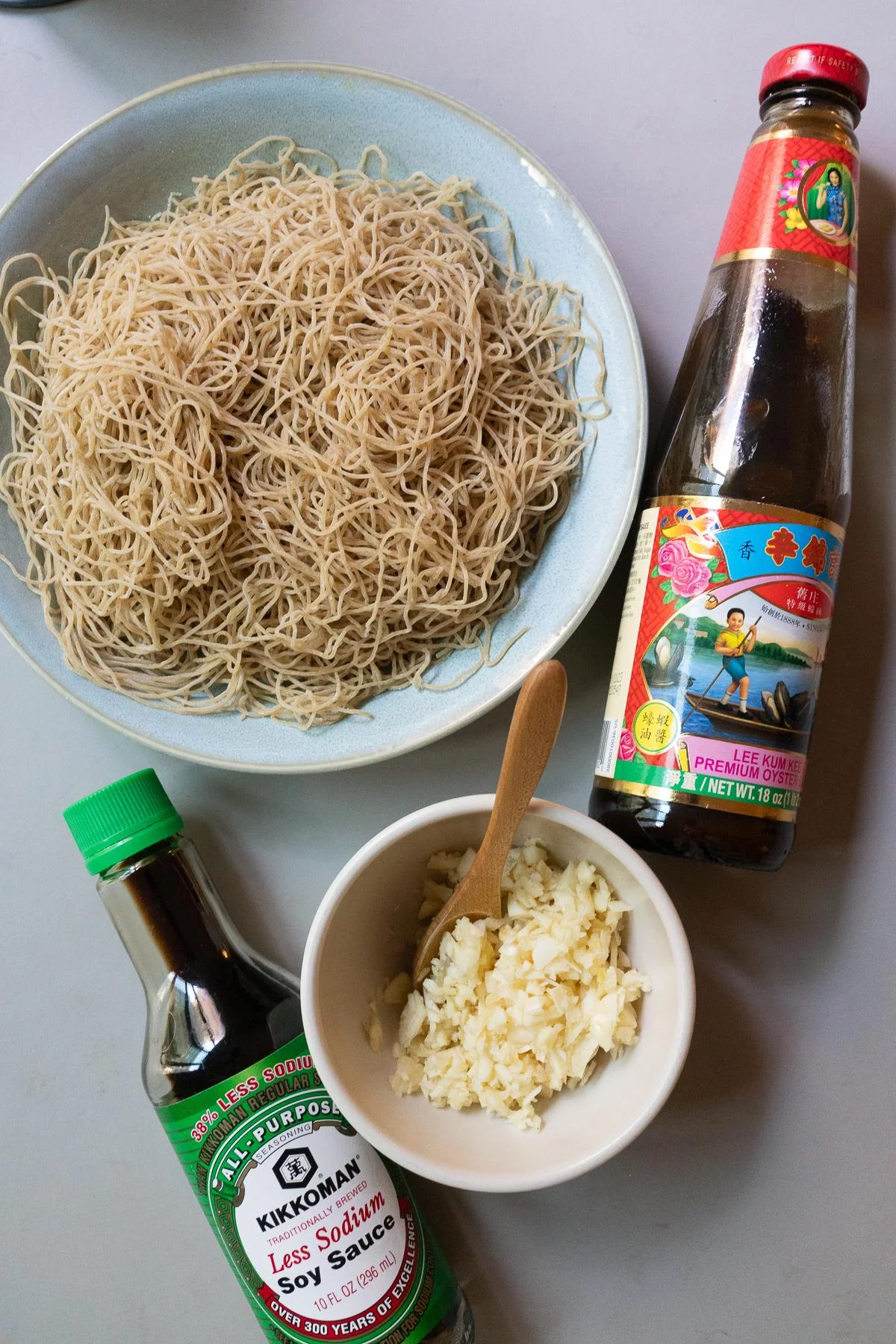 Ingredients for Gon Lo Mein: thin egg noodles, garlic, oyster sauce, and soy sauce.
