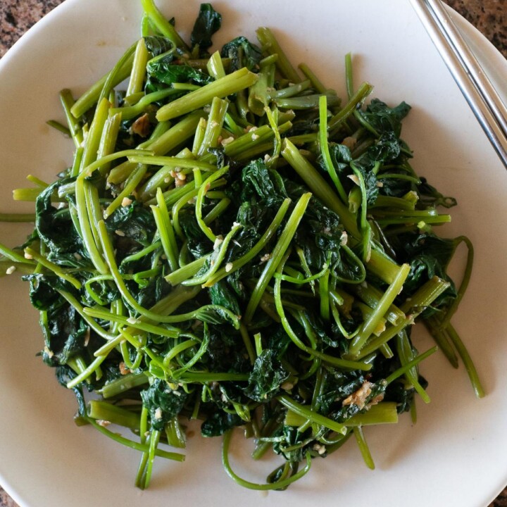 Stir fried ong choy on a plate, ready to eat.