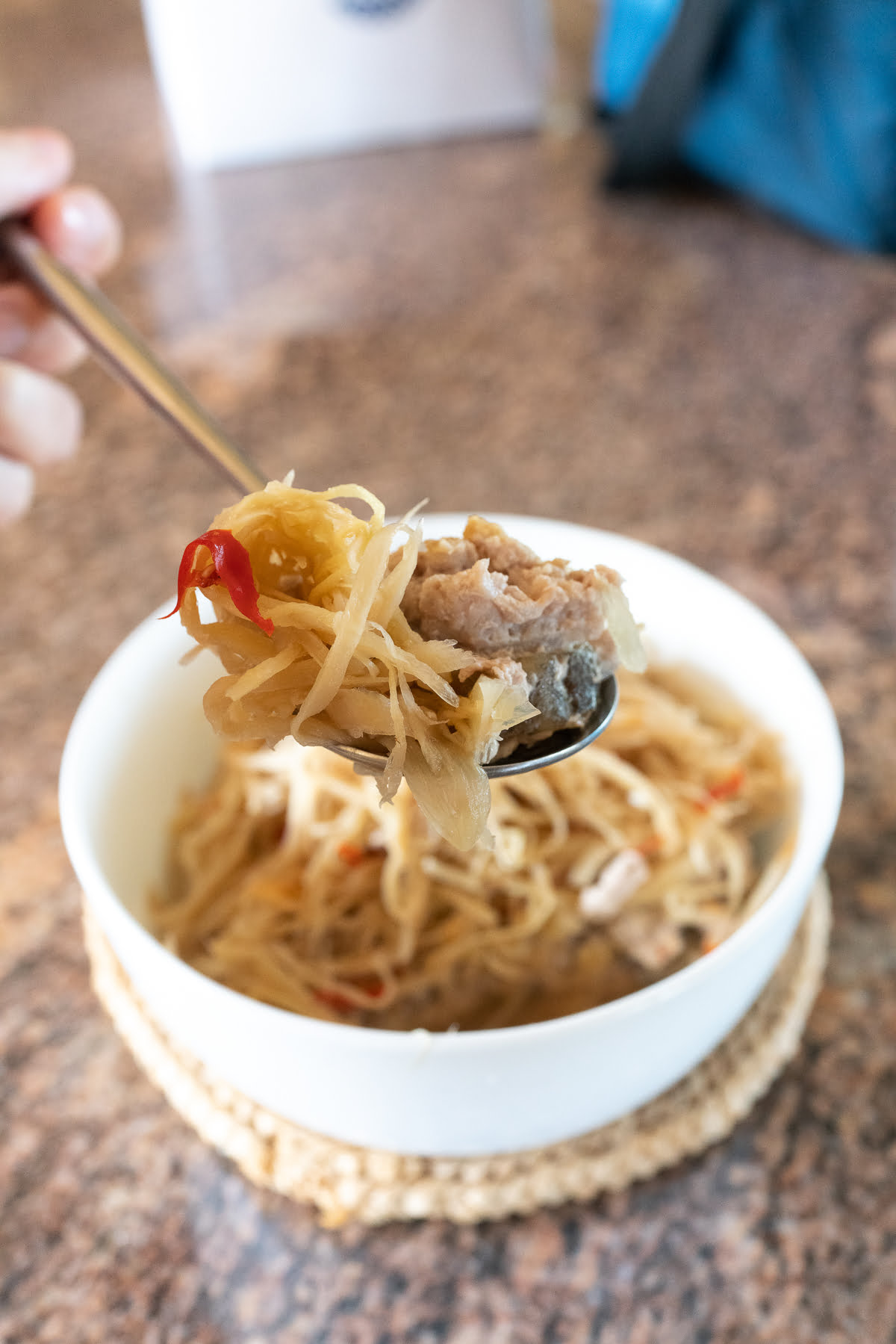 A spoonful of Steamed Pork With Salted Fish