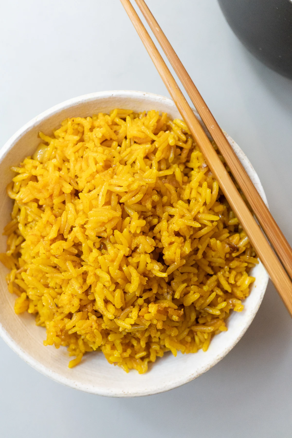 A bowl of freshly cooked turmeric rice.