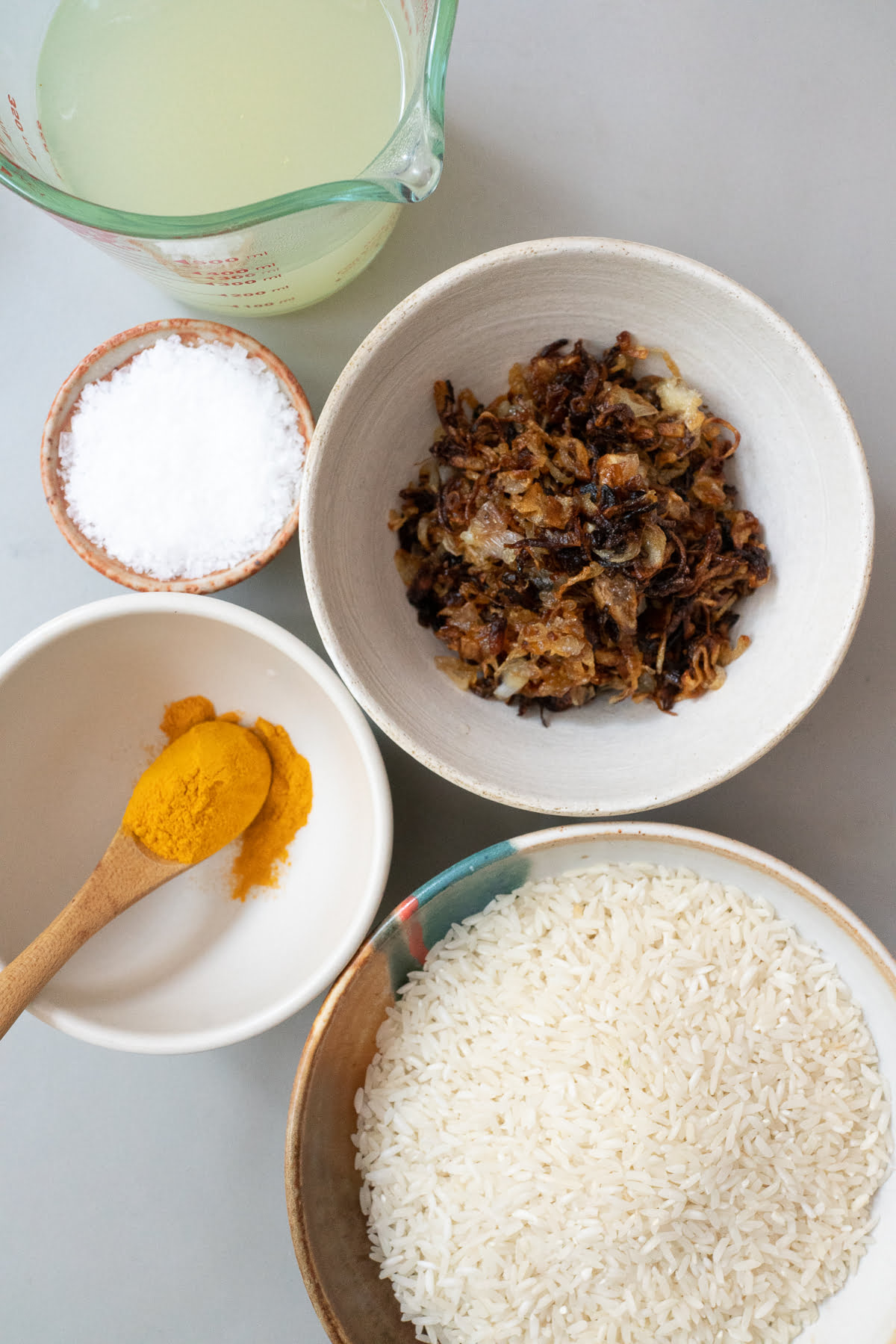 Ingredients for Turmeric Rice (basmati rice, shallots, turmeric powder, chicken broth, and salt).
