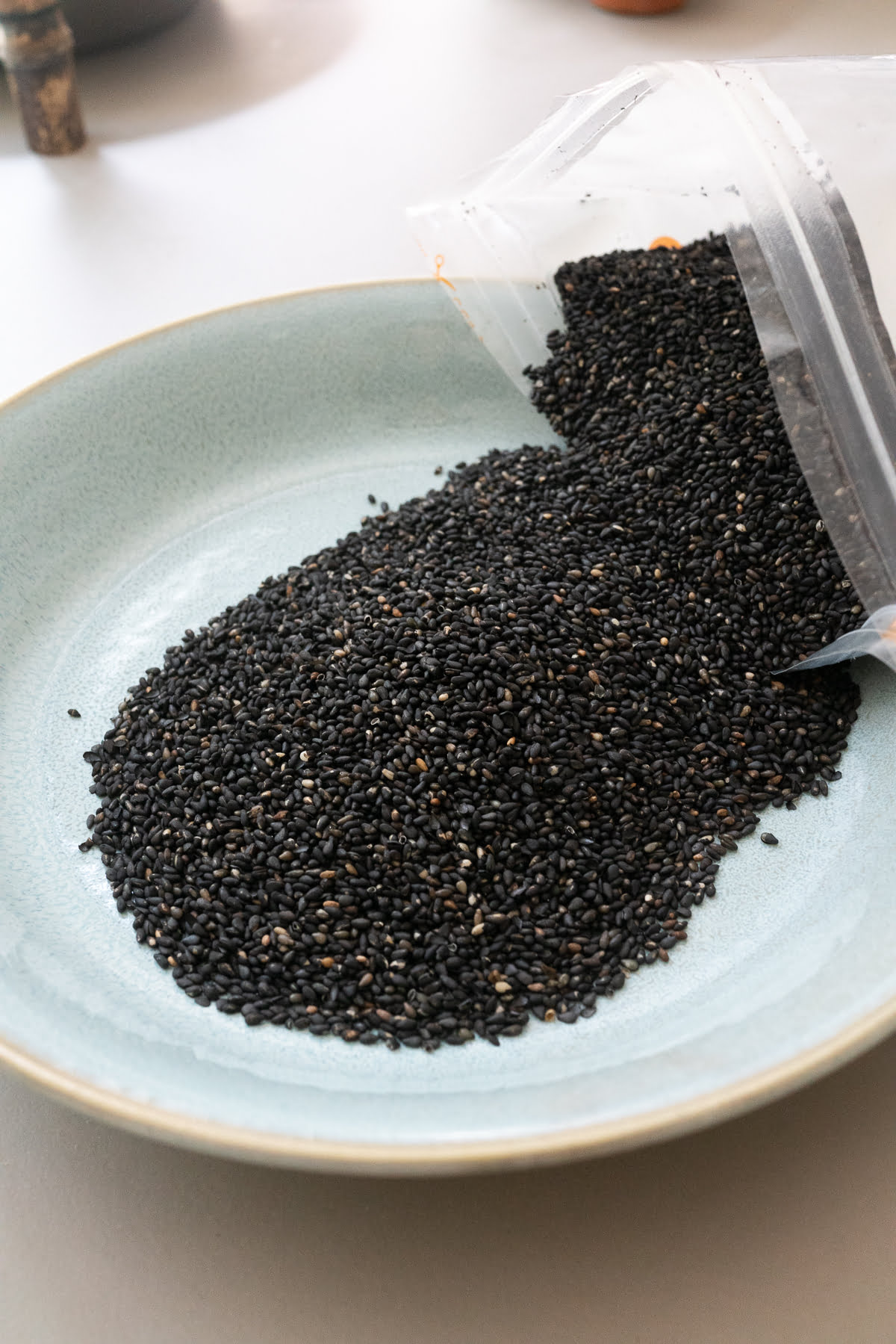 A dish of roasted black sesame seeds.