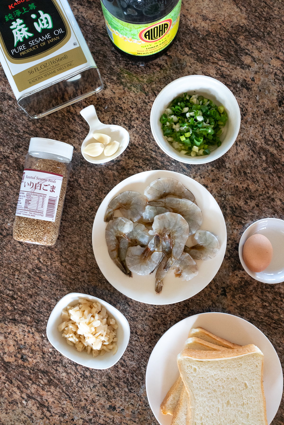 Ingredients for Shrimp Toast: shrimp, egg, water chestnuts, garlic, green onions, soy sauce, sesame oil, sesame seeds, and white bread.