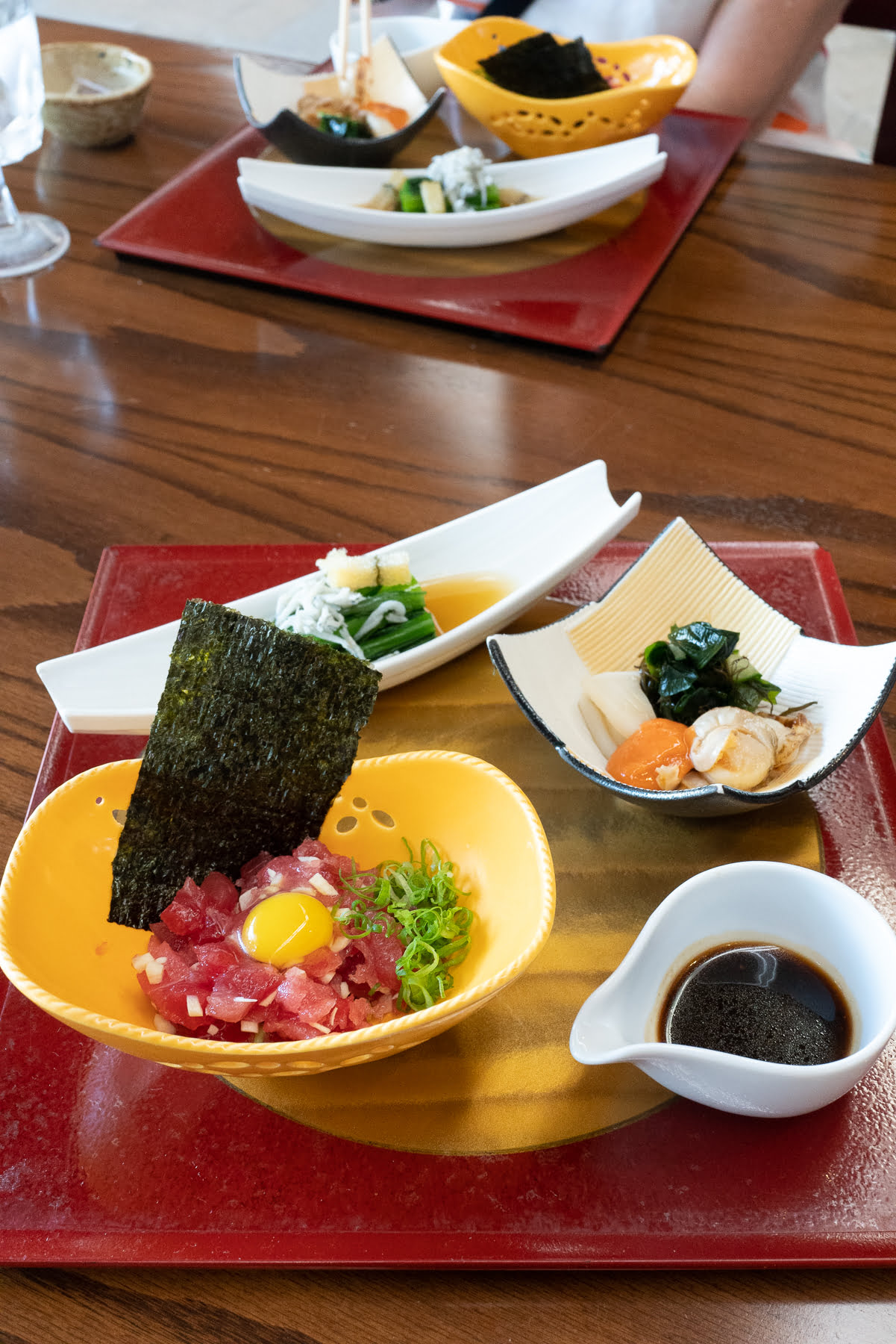 Course 1 of the Shusaizen Set from Restaurant Suntory, featuring Tuna Tartar with Heart of Palm, Avocado, and Quail Egg, Scallop and Squid Nuta, and Choy Sum Karashi-zuke.