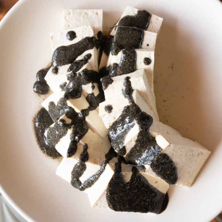 A prepared dish of Black Sesame Sauce On Steamed Tofu