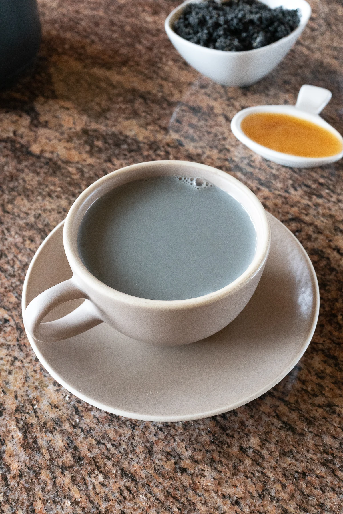 A cup of black sesame soy milk, ready to drink.