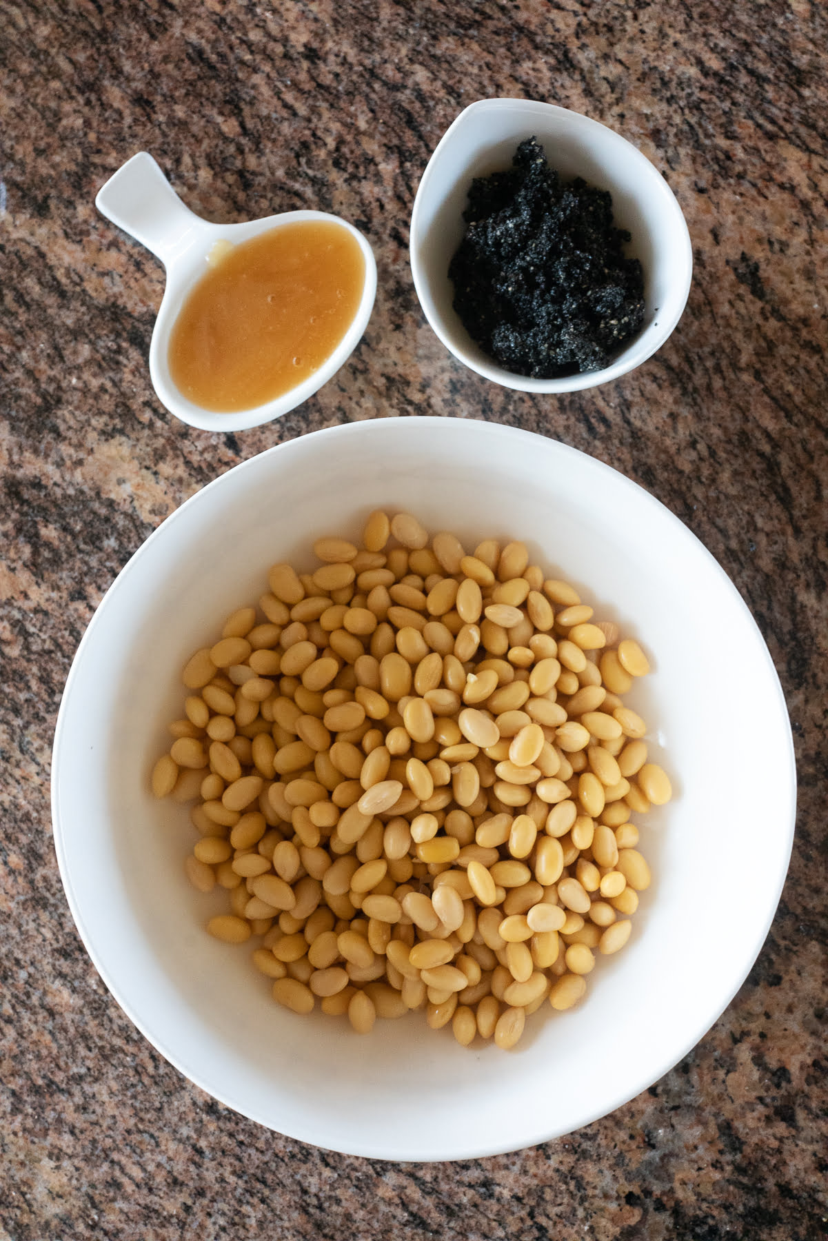 Ingredients for black sesame soy milk (soybeans, black sesame paste, and honey).