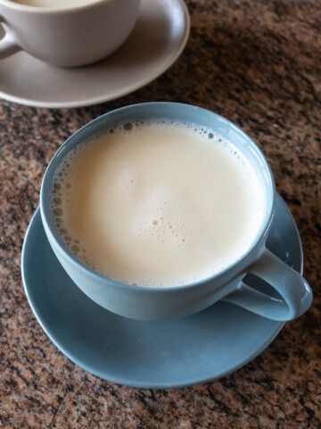 A cup of homemade soy milk, ready to drink.