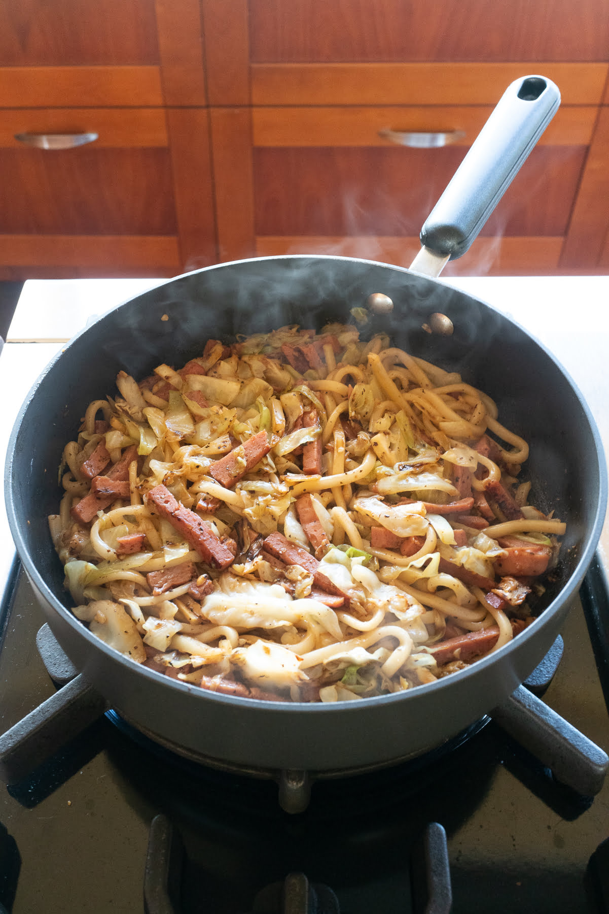 Prepared udon stir fry in a pan, ready to serve and eat!