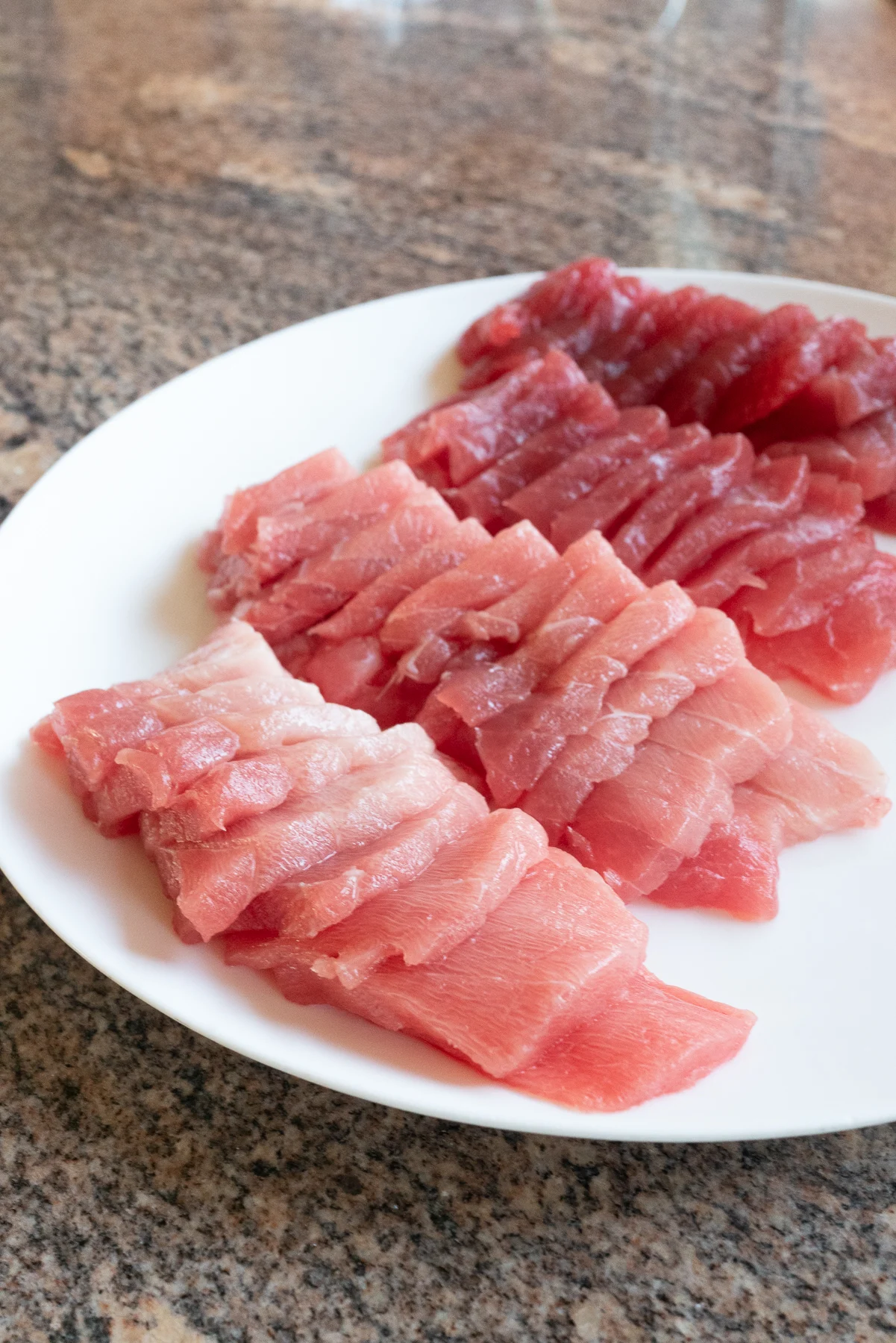 A plate of fresh ahi sashimi, sliced and ready to use for homemade sushi.
