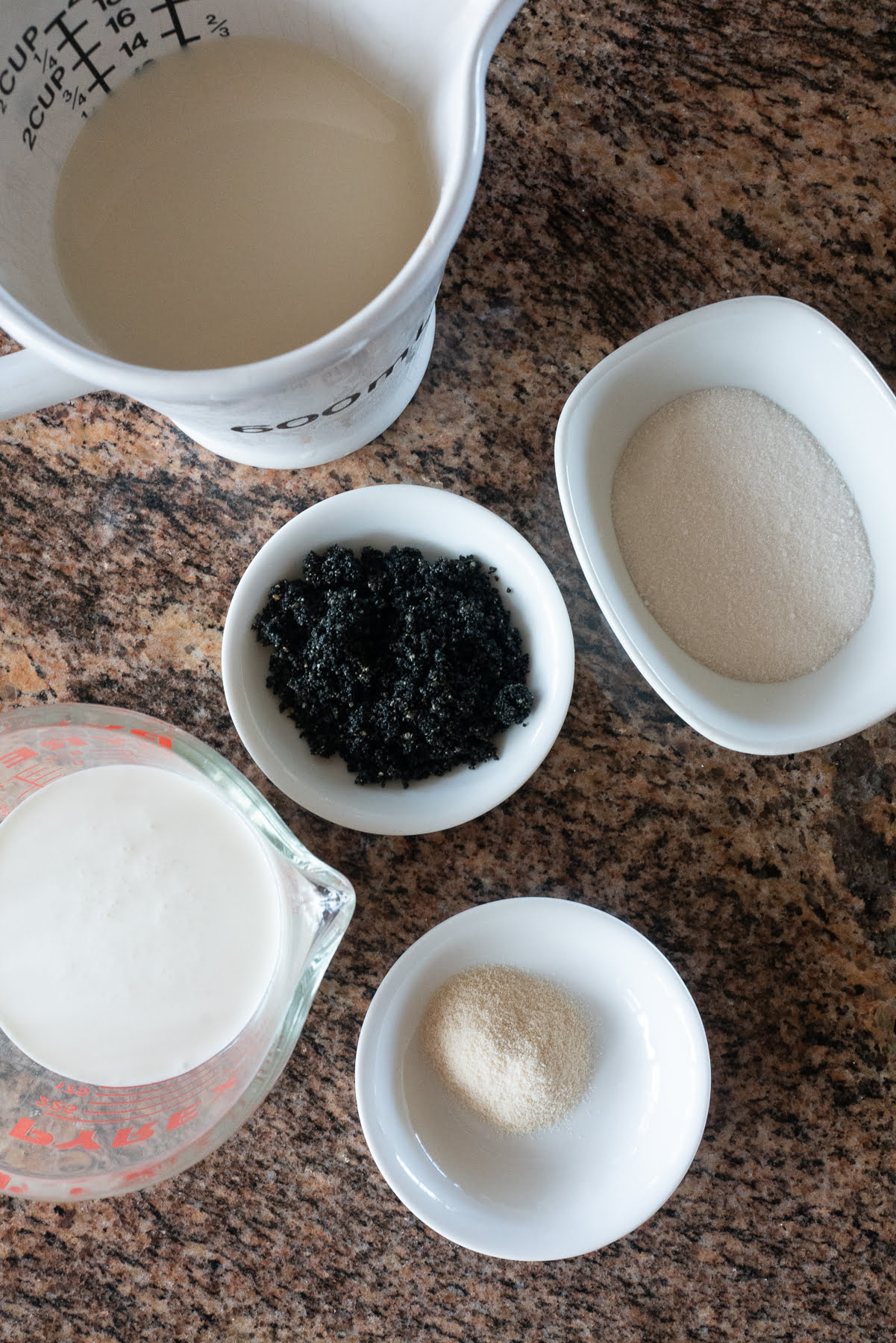 Ingredients to make black sesame and soy milk pudding laid out on a countertop.