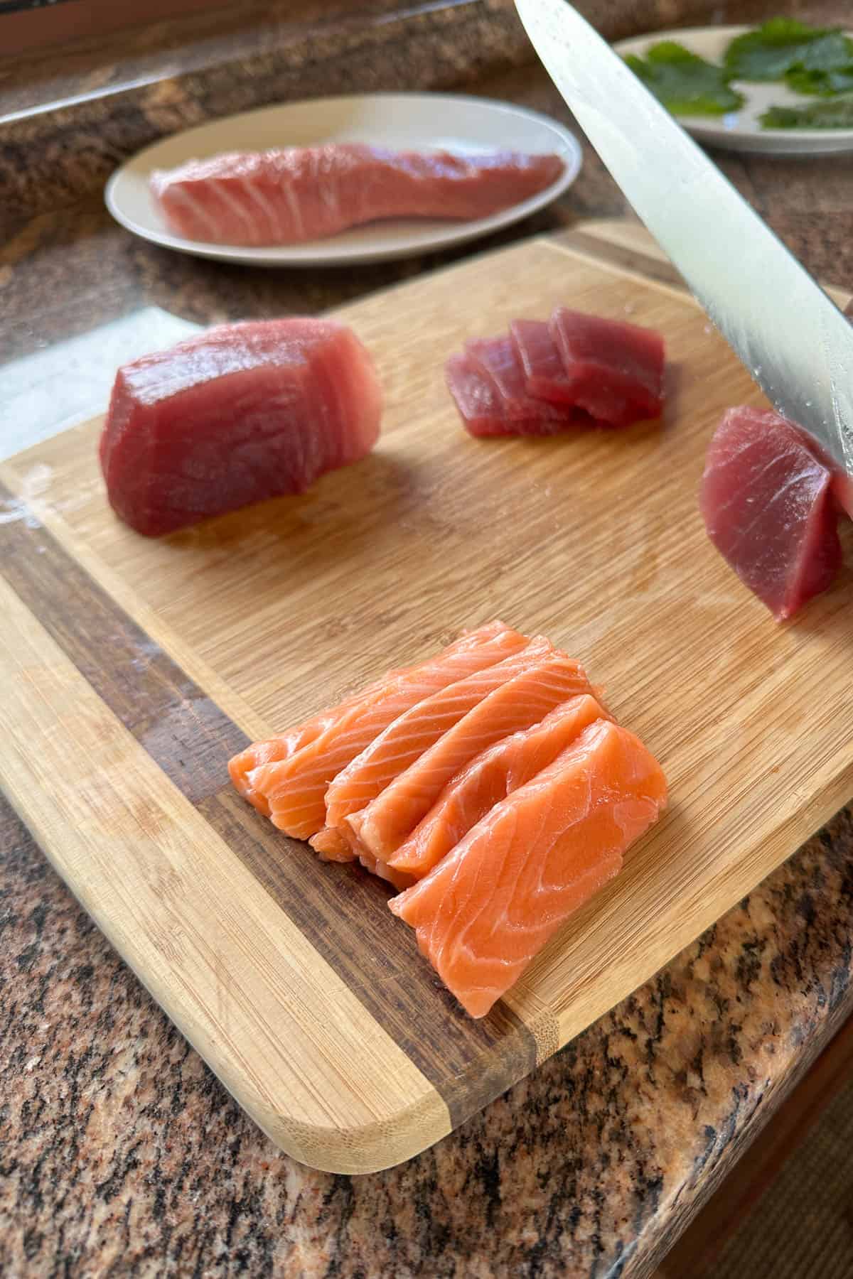 Slicing sashimi to make sushi cake.