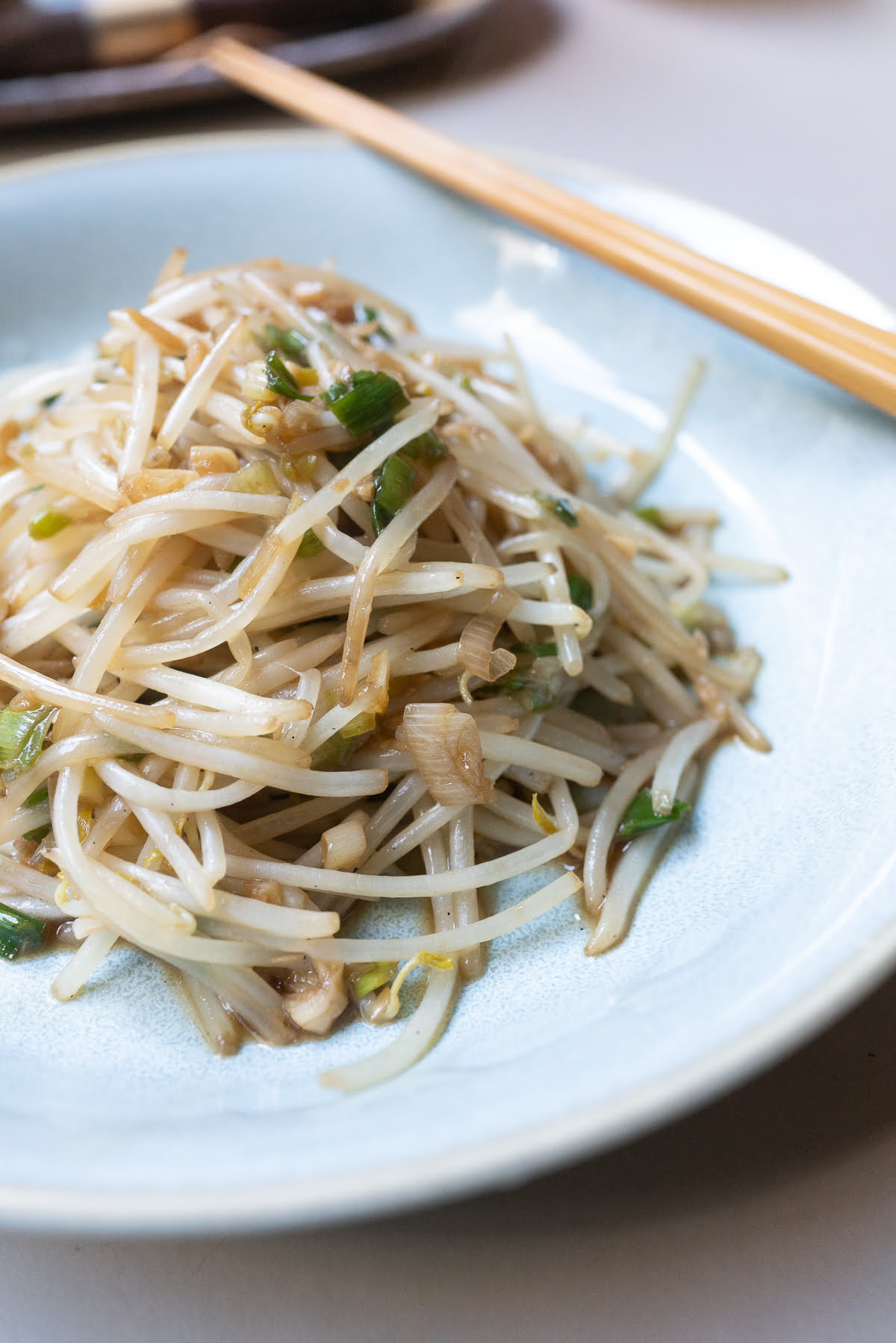 A plate of bean sprouts stir fry, ready to eat.