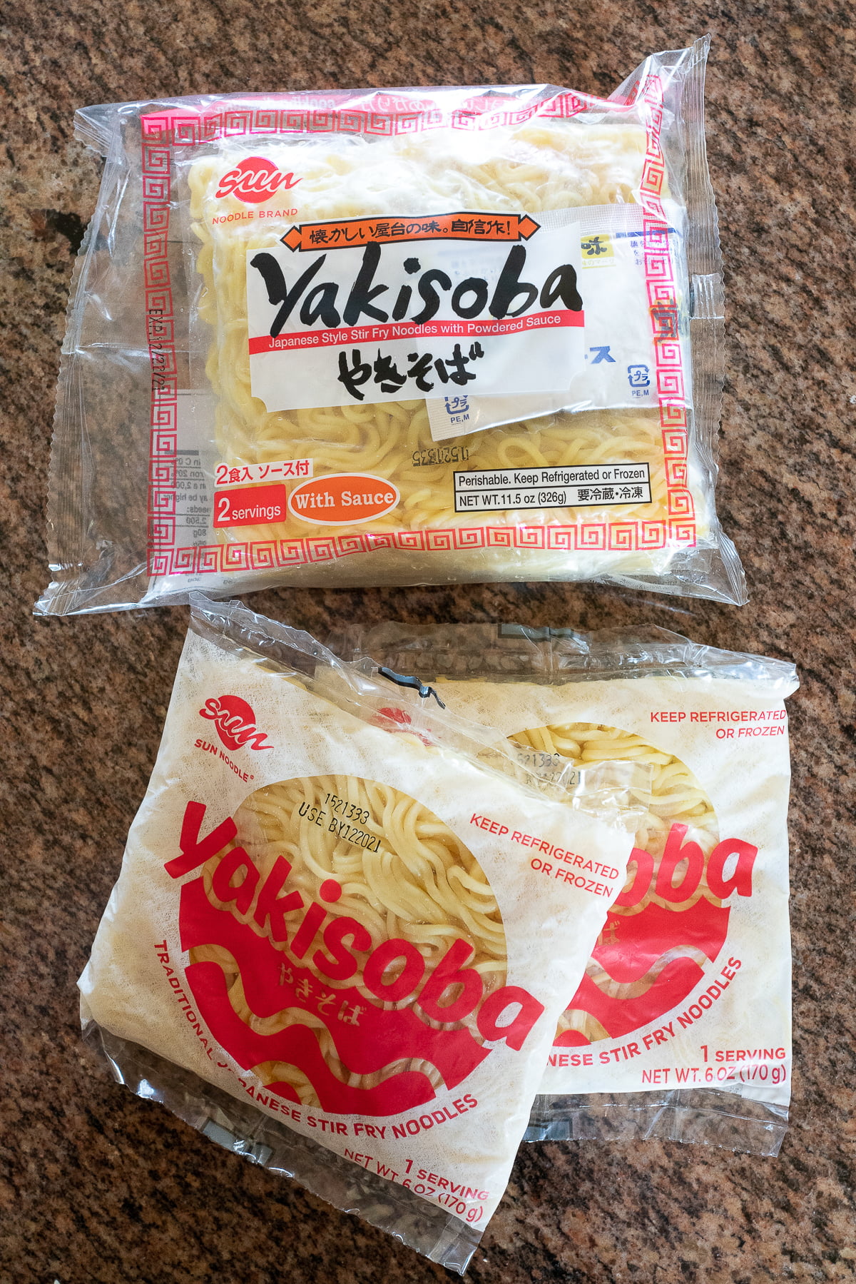 Three packages of yakisoba noodles from Sun Noodle on a counter.