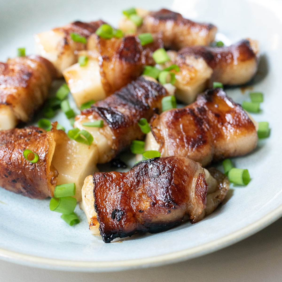 A plate of bacon wrapped mochi.