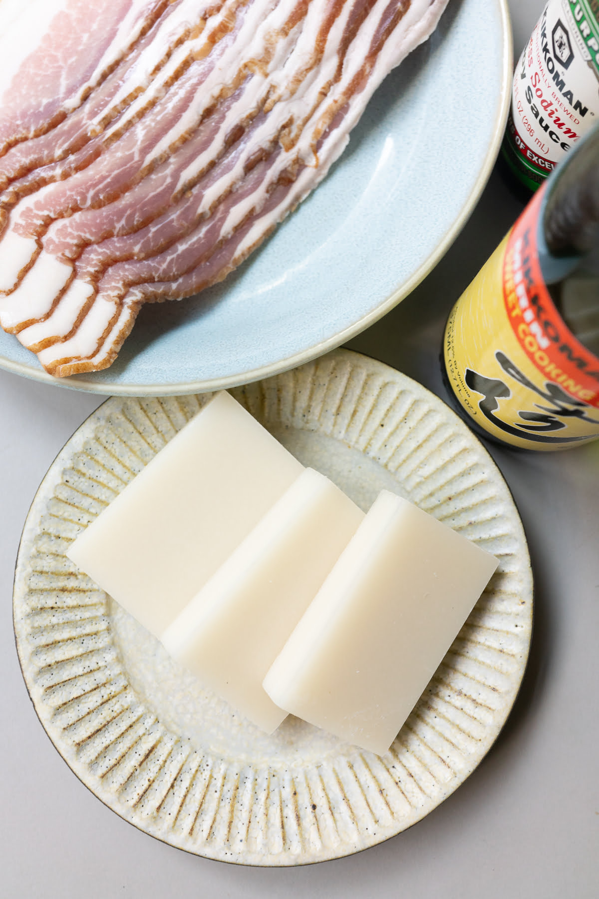 Ingredients for bacon wrapped mochi (bacon, mochi, soy sauce, and mirin).