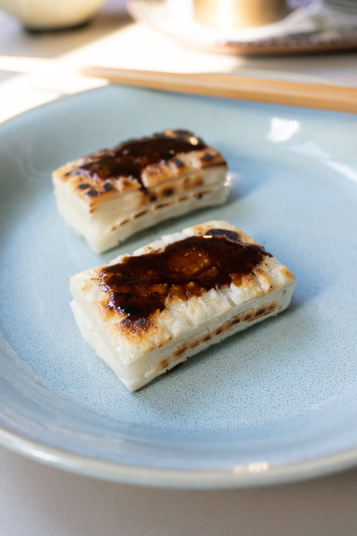 Pan fried kirimochi with soy sauce glaze brushed on top.