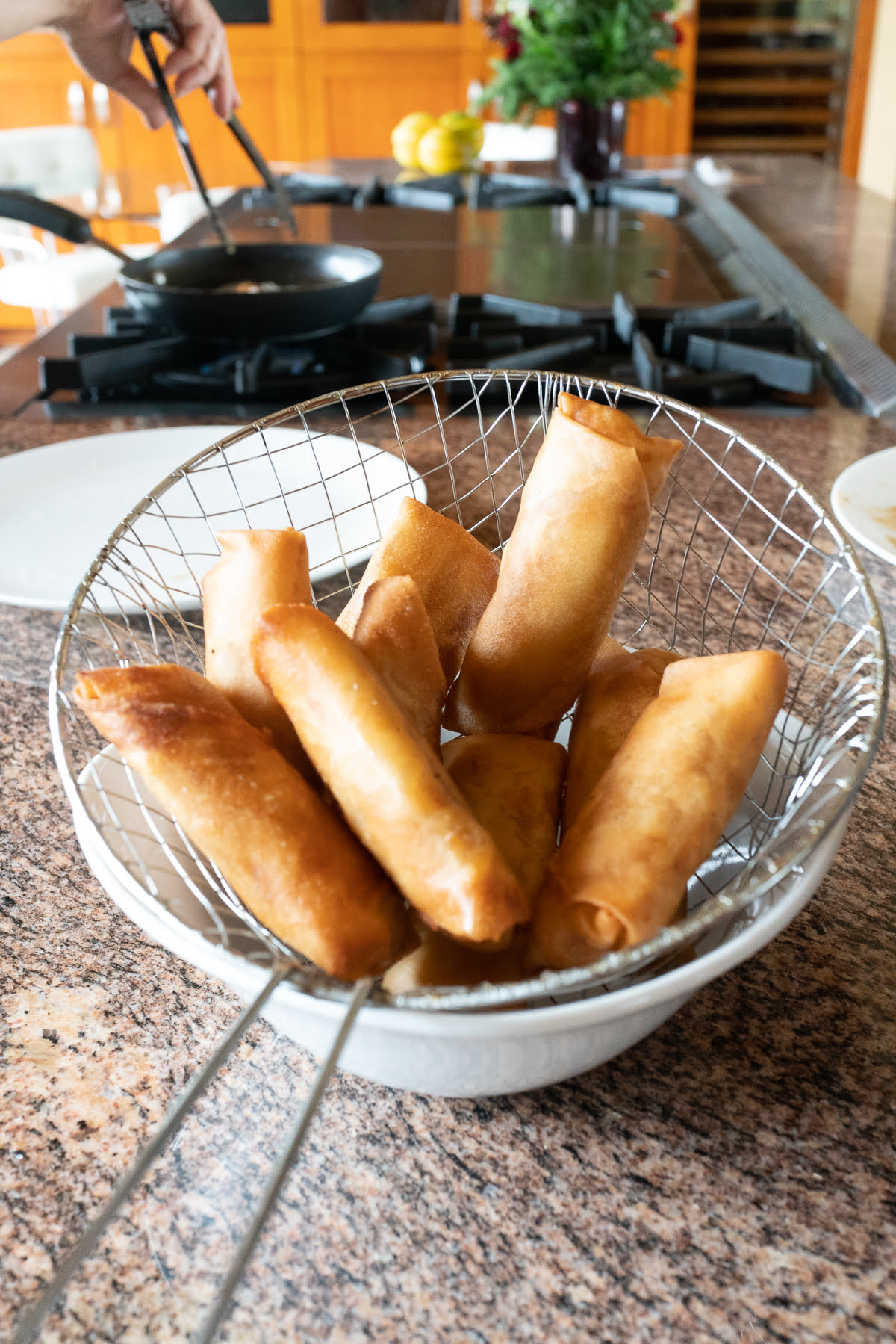 A batch of banana lumpia straight from the fryer, hot and fresh.