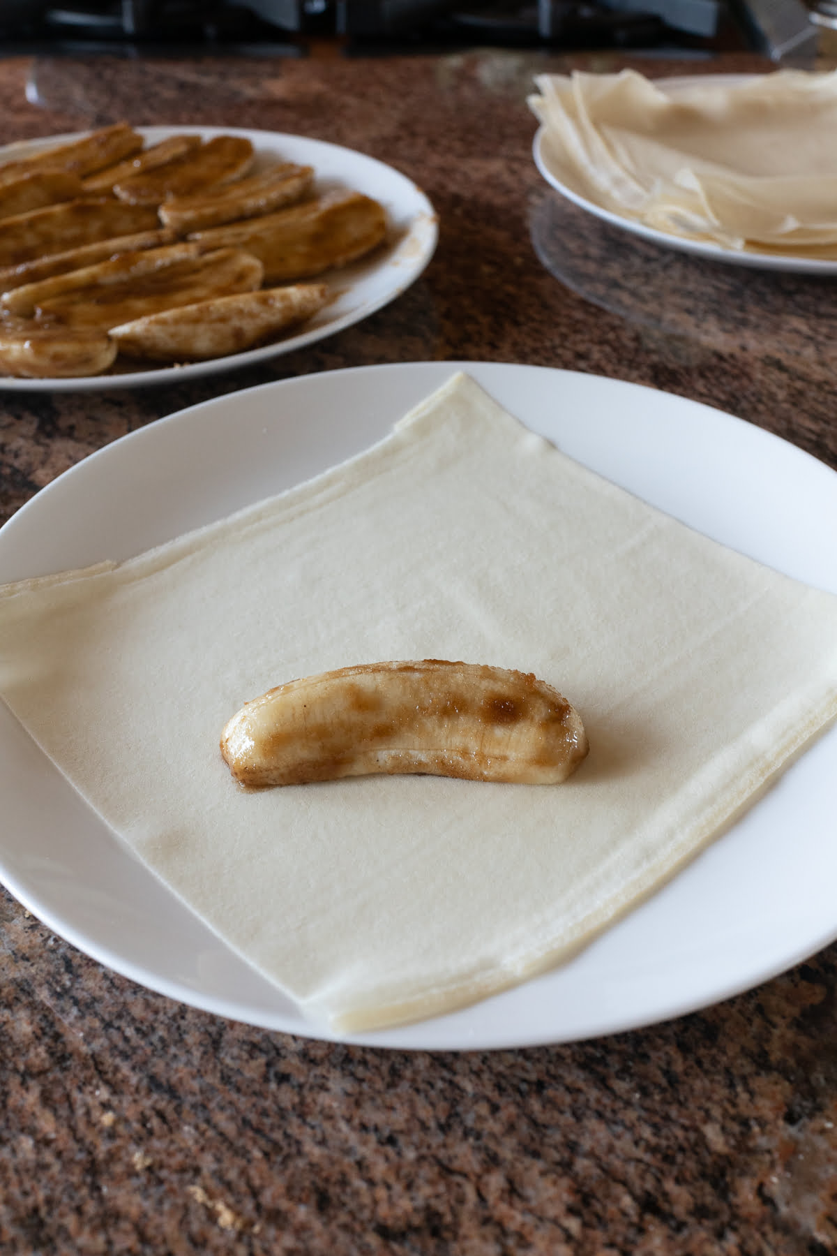 Apple banana half rolled in brown sugar and placed on top of a lumpia wrapper.