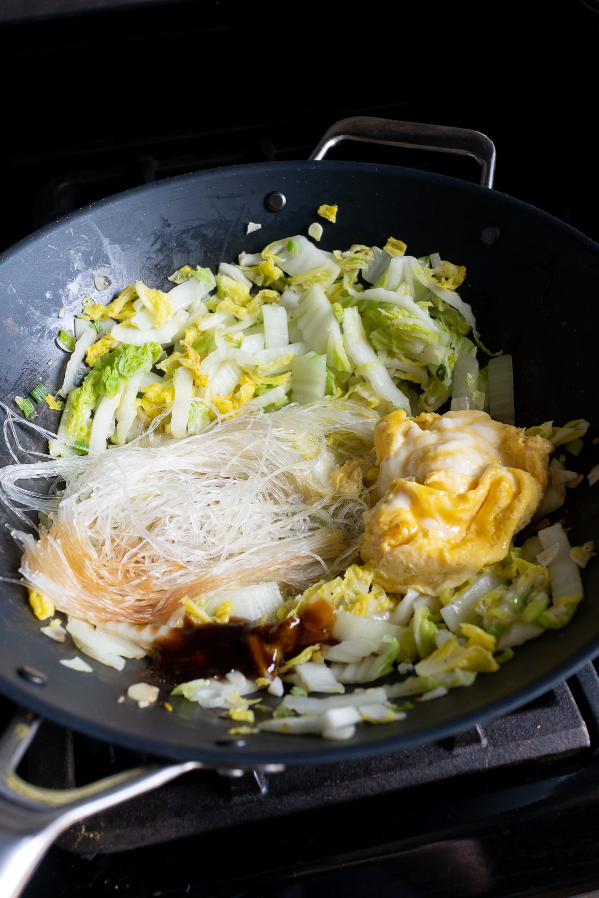 Cooking the Glass Noodles and Cabbage Stir Fry in a wok.