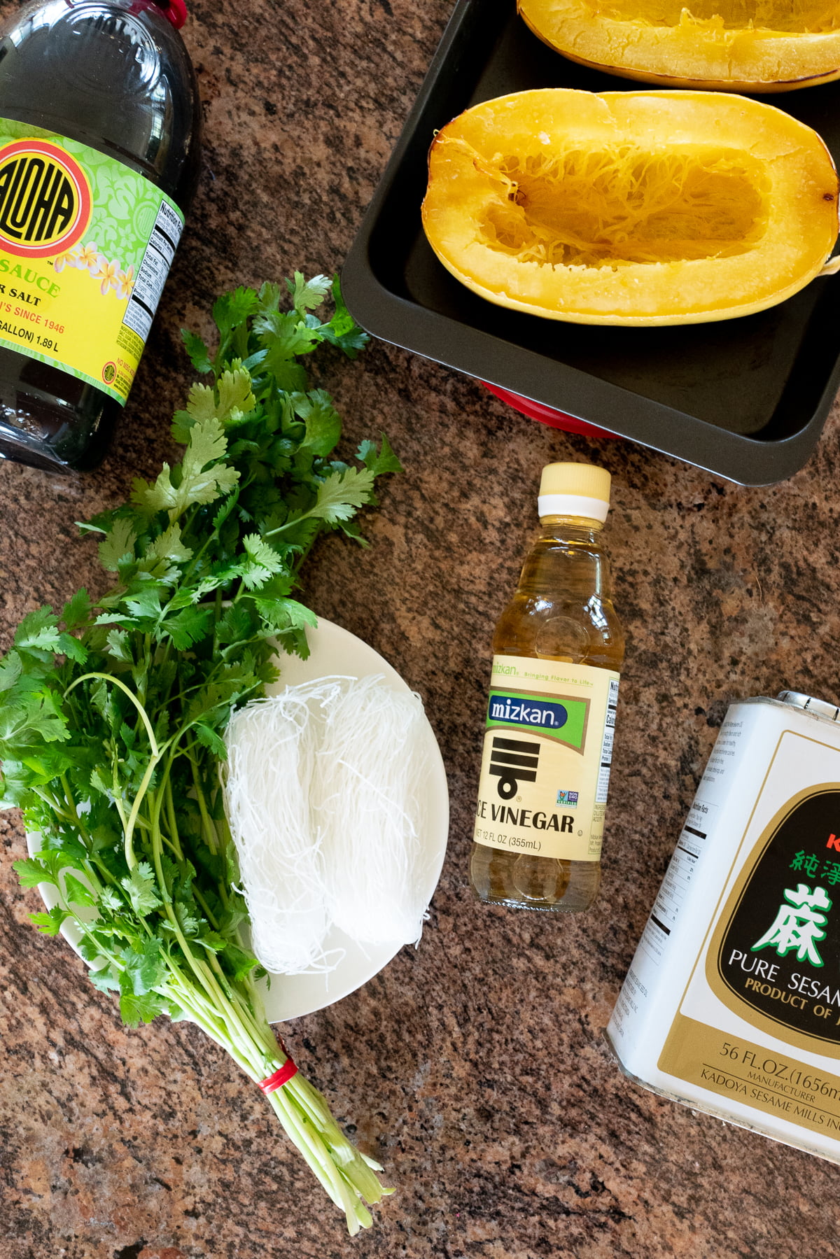 Ingredients for Spaghetti Squash and Glass Noodle Salad (spaghetti squash, glass noodles, cilantro, soy sauce, Maggie, rice vinegar, sesame oil, sugar, and salt).