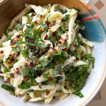 A bowl of parsley pasta, ready to eat.