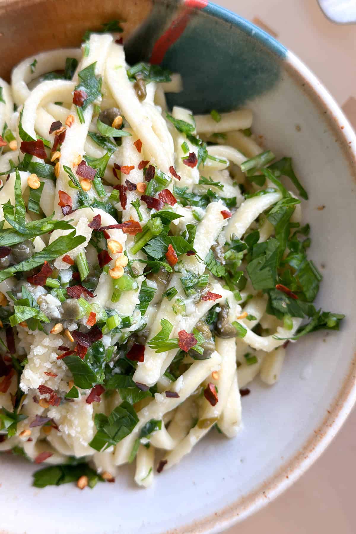 A bowl of parsley pasta, ready to eat.