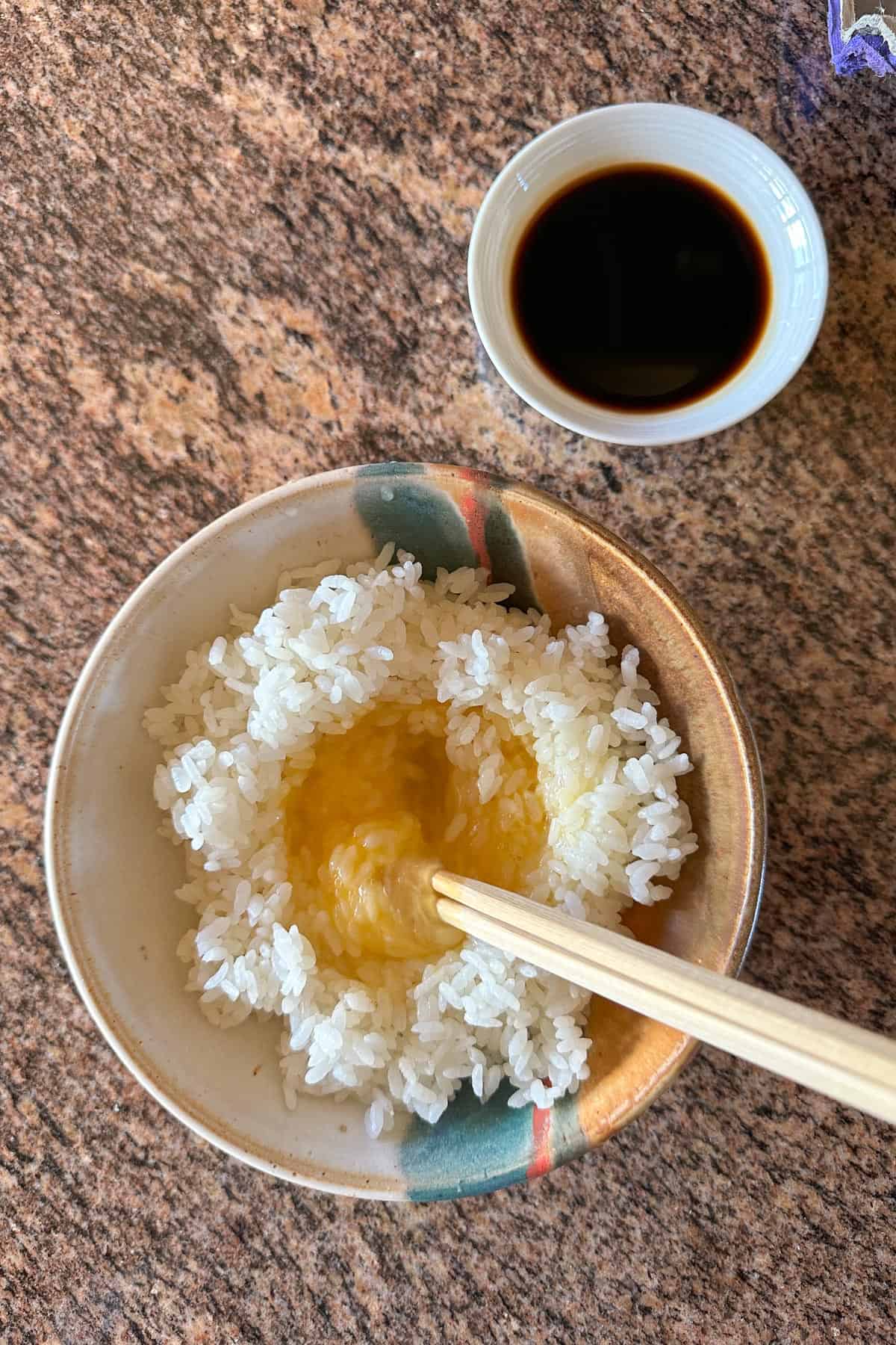 Stirring the raw egg into the hot rice to make Tamago Kake Gohan.