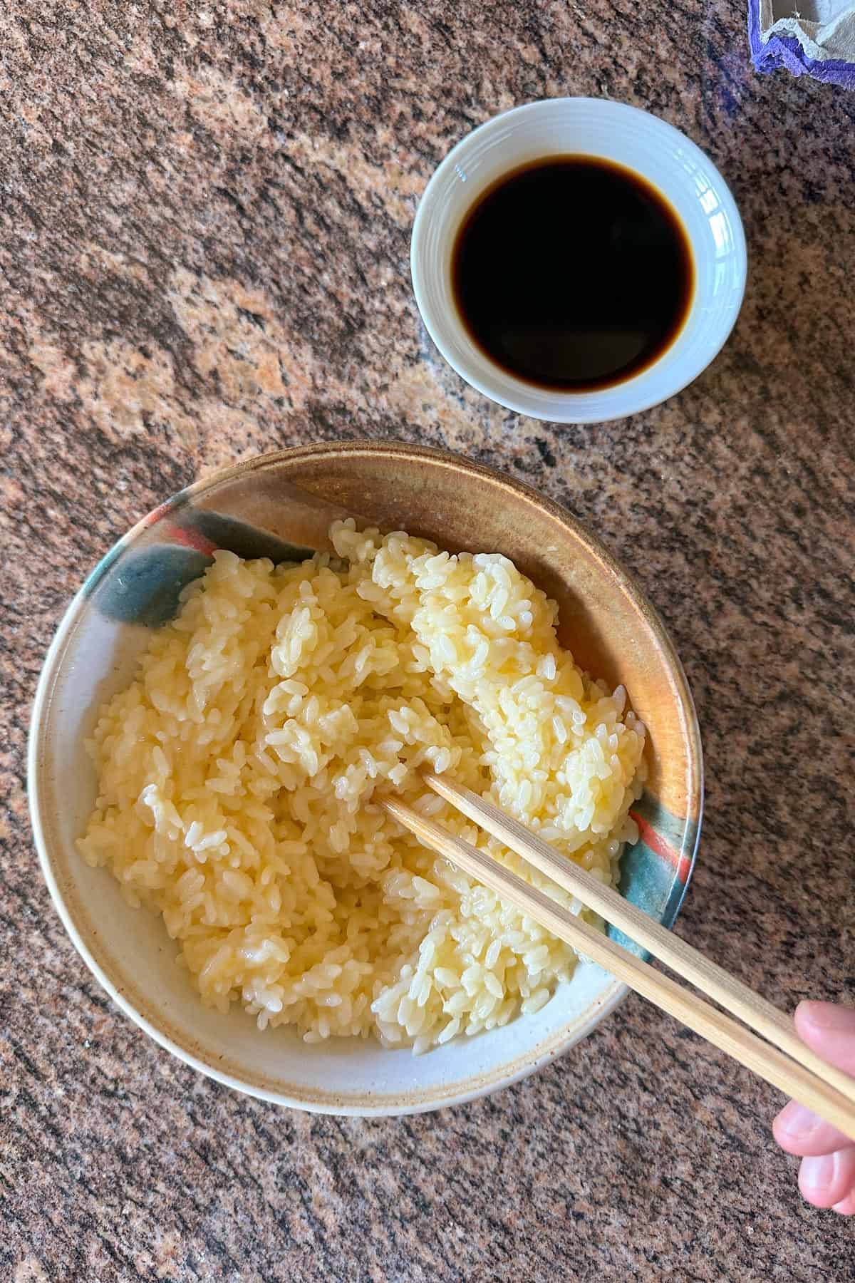 Stirring the raw egg into the hot rice to make Tamago Kake Gohan.