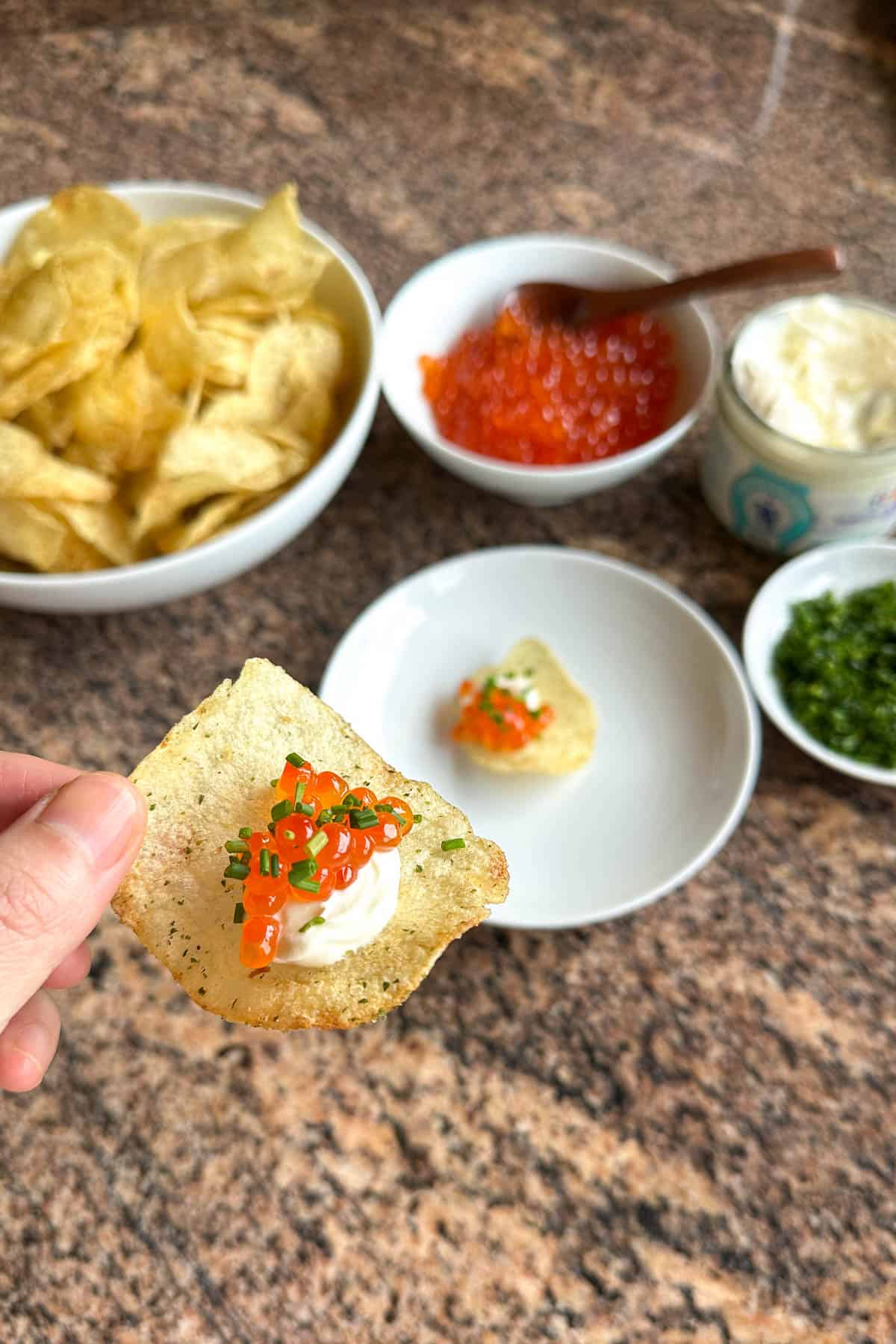 Chips topped with crème fraîche, ikura (salmon roe), and chives.