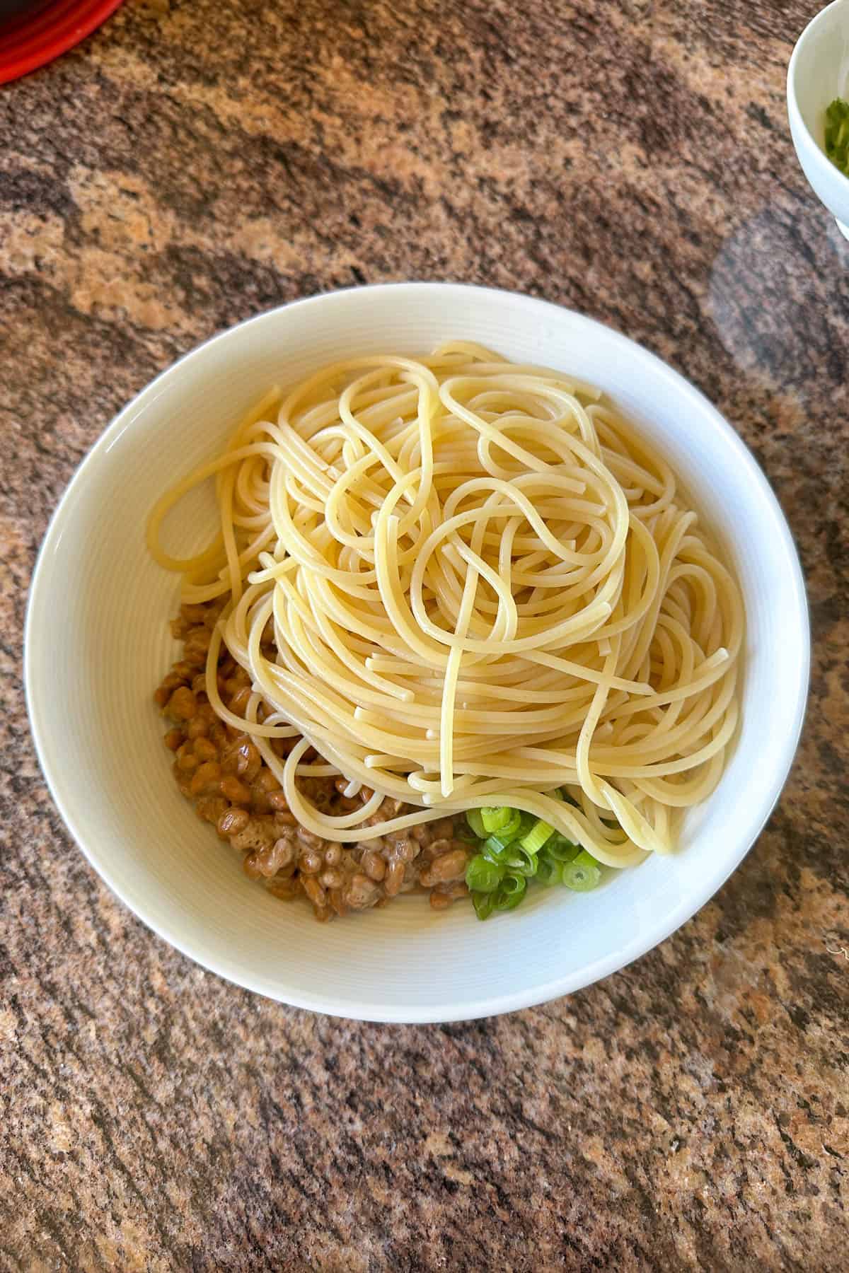 Mixing the ingredients to make Natto Spaghetti.