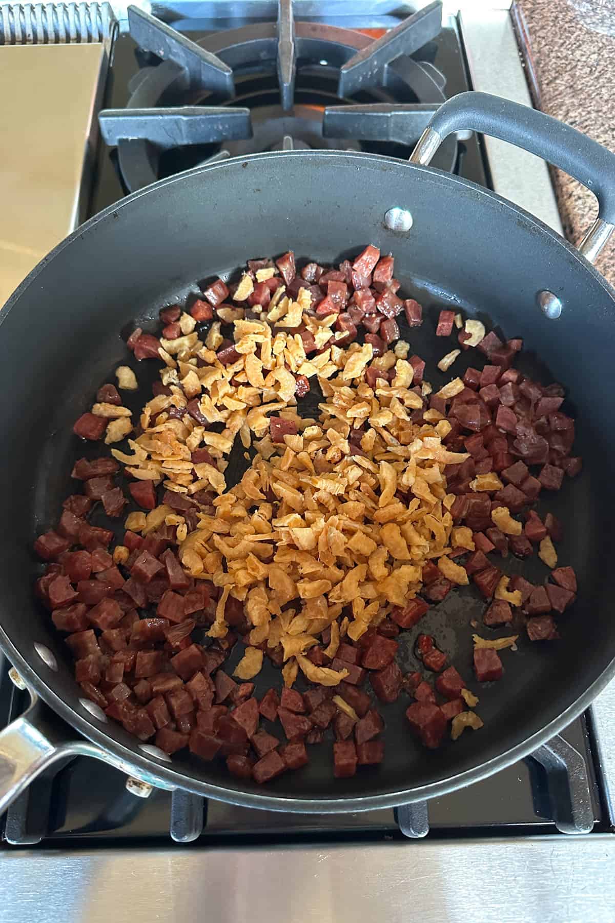 Stir frying ingredients to make taro cake.