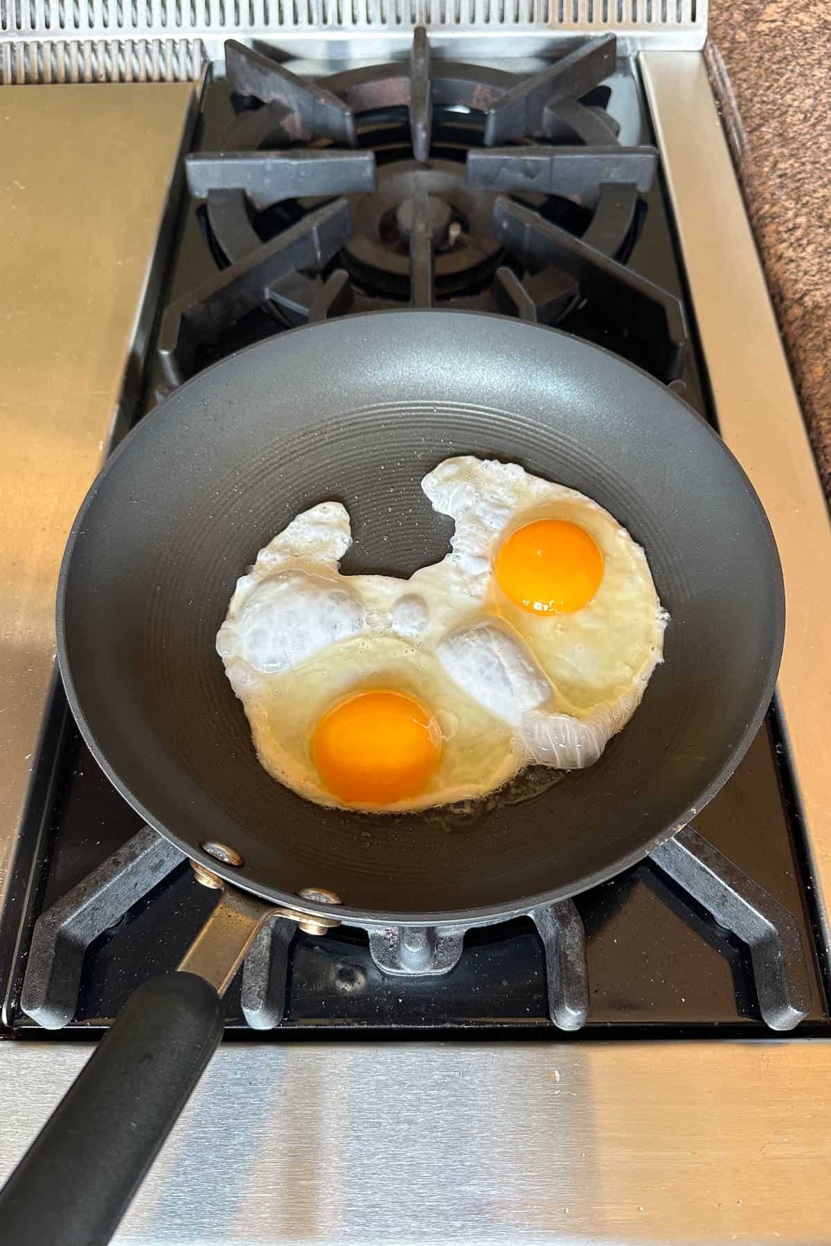 Making pan fried eggs.