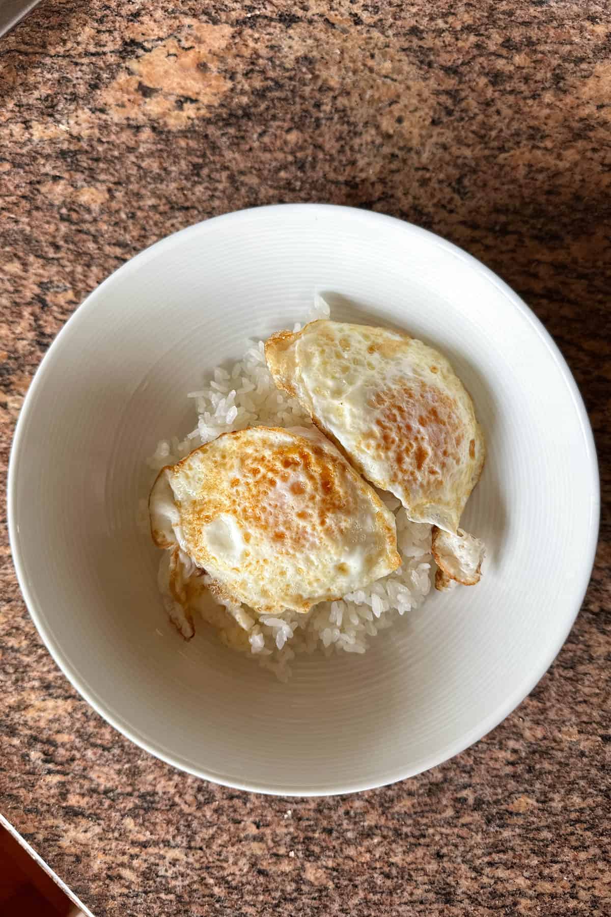 Over easy eggs on rice.