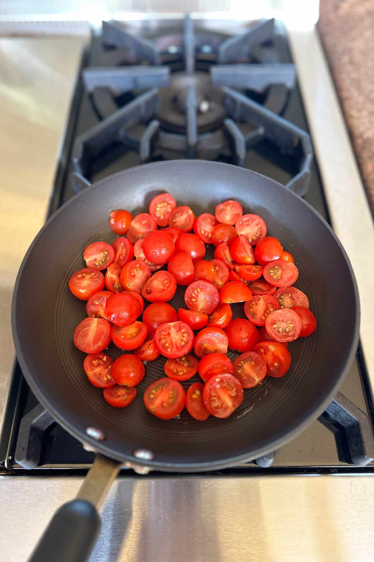 Making cherry tomato pasta.