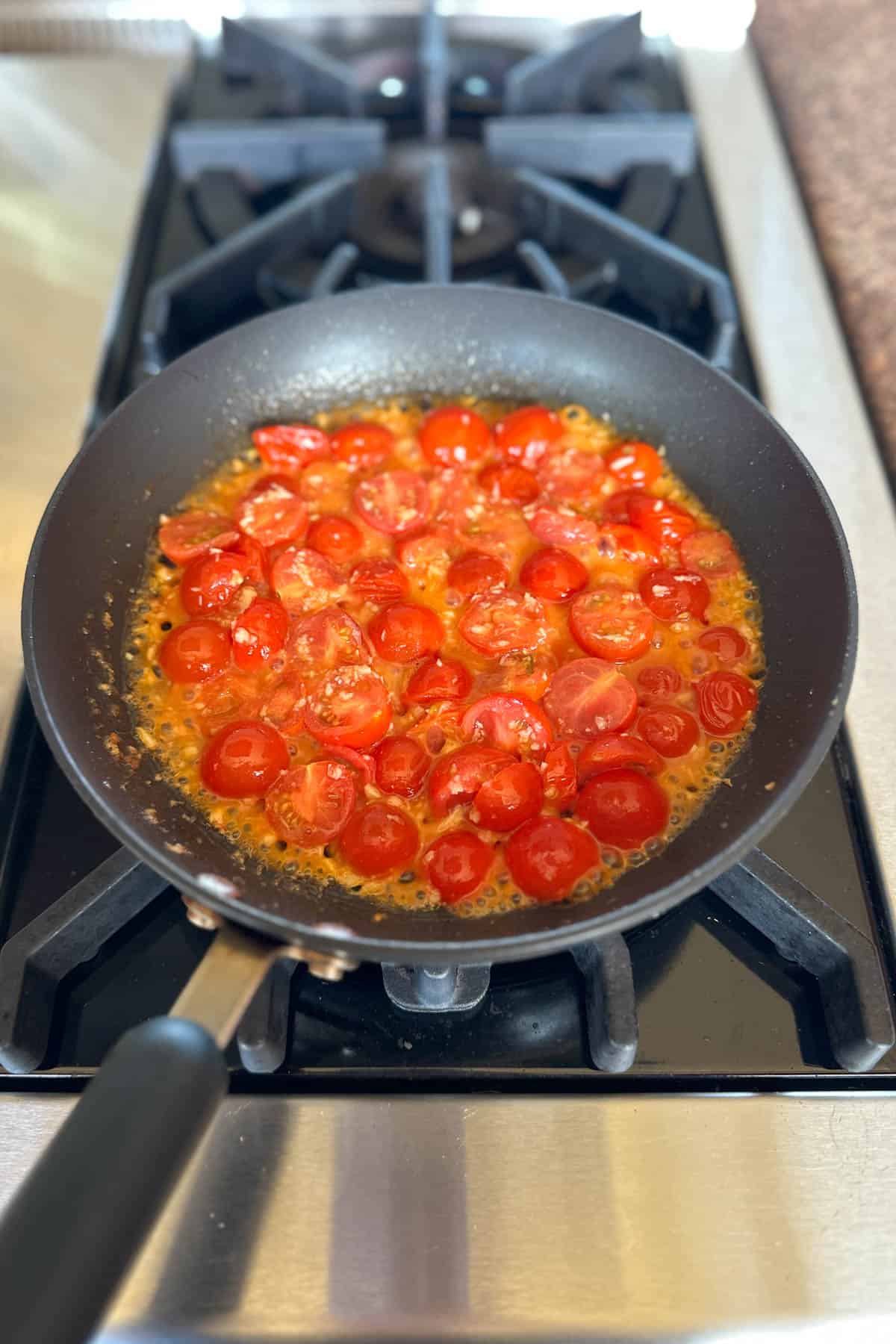 Making cherry tomato pasta.