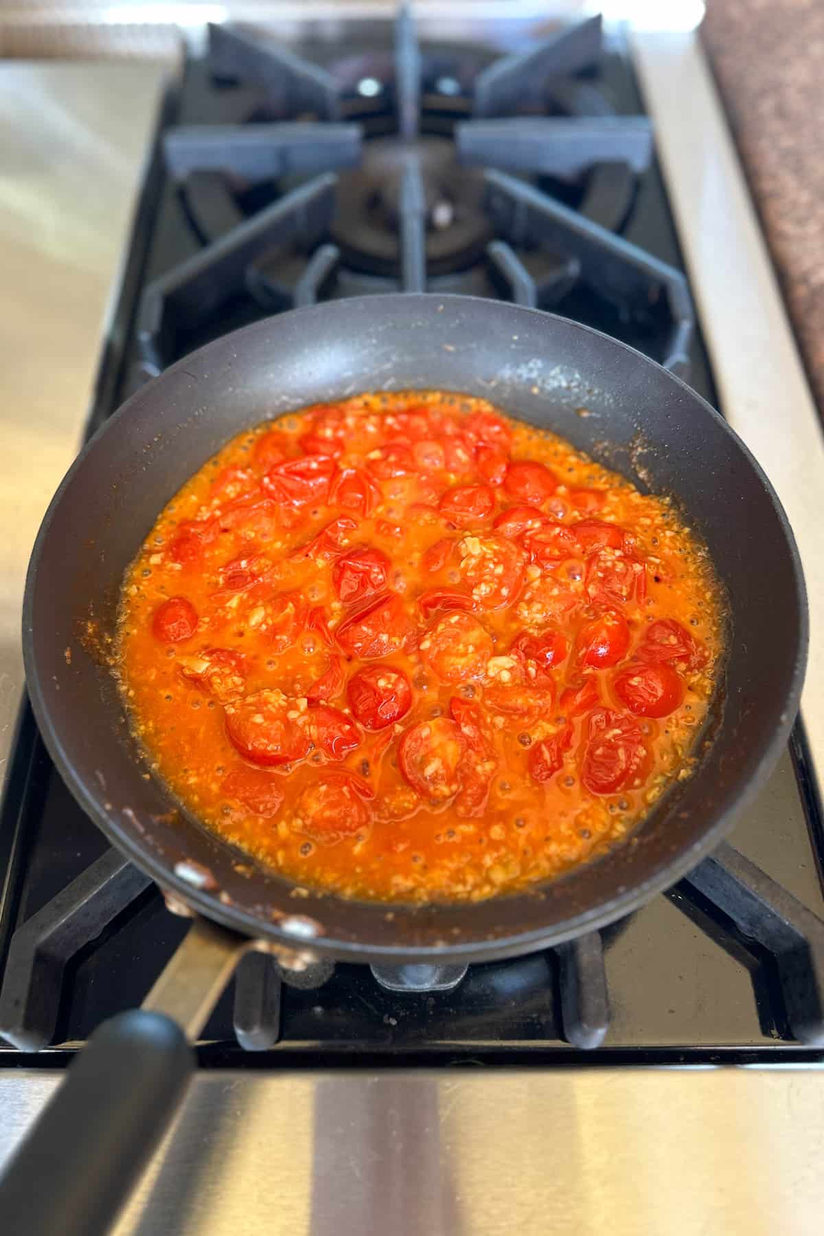 Making cherry tomato pasta.