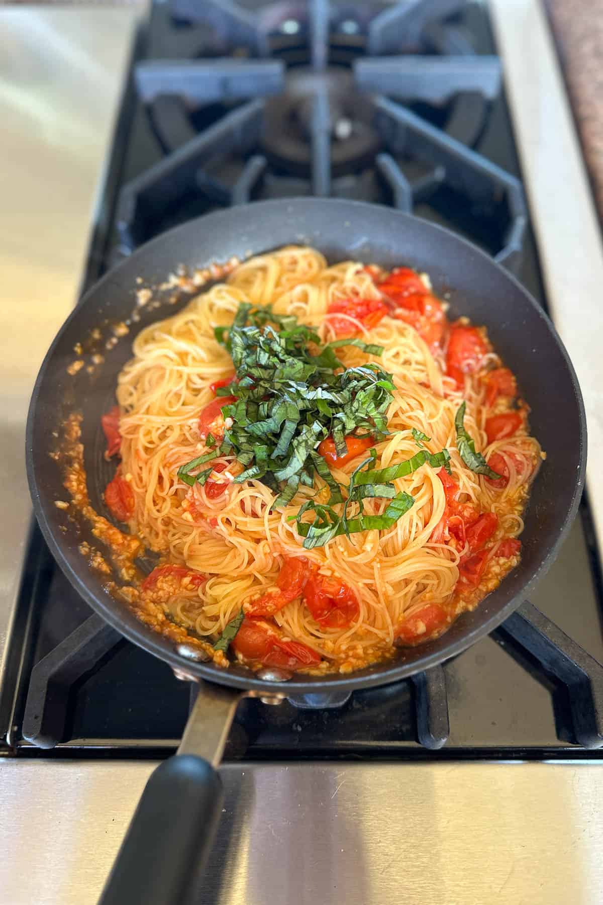 Making cherry tomato pasta.