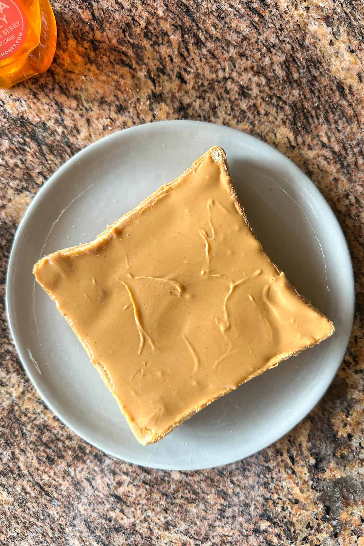 Spreading peanut butter for Peanut Butter and Honey Toast.