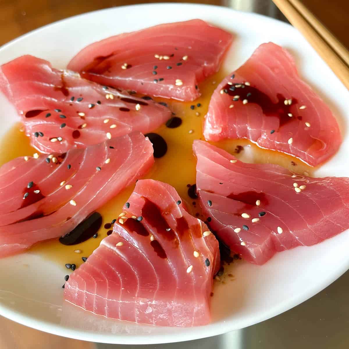 Ahi tuna sashimi with sesame oil and soy sauce.