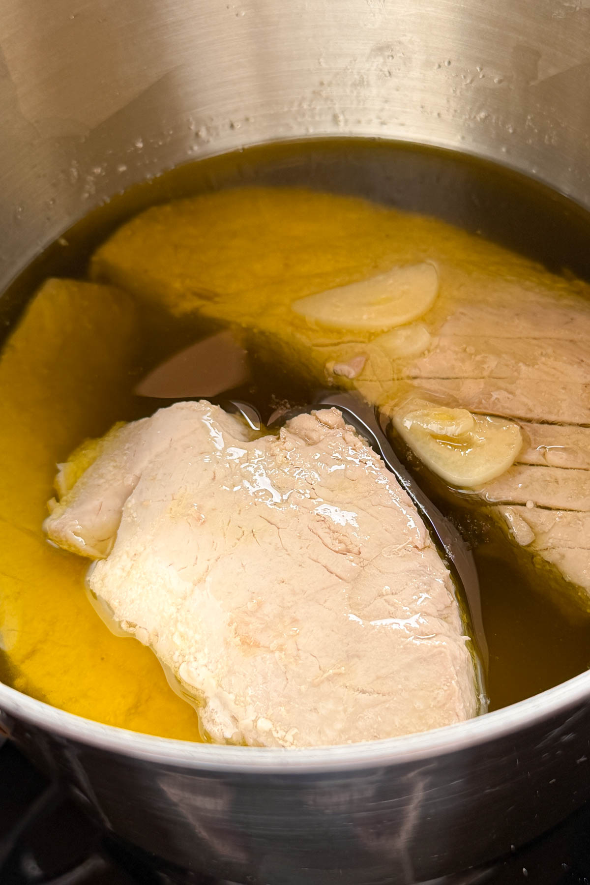 Poaching tuna for tuna confit.