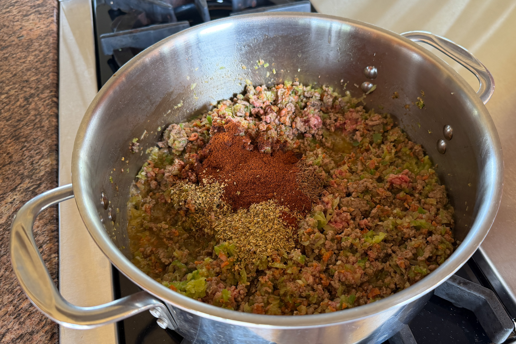 Making Zippy's chili, adding spices.