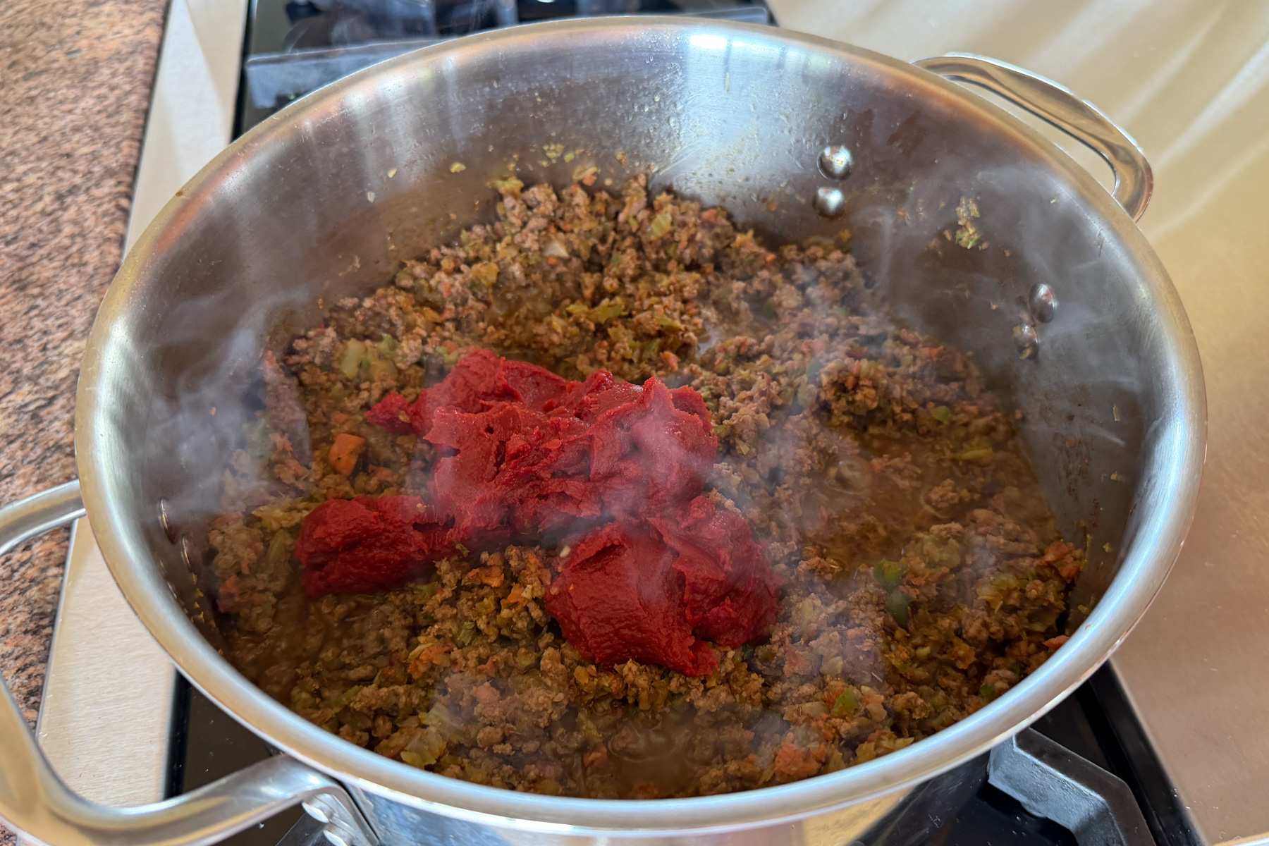 Making Zippy's chili, adding tomato paste.